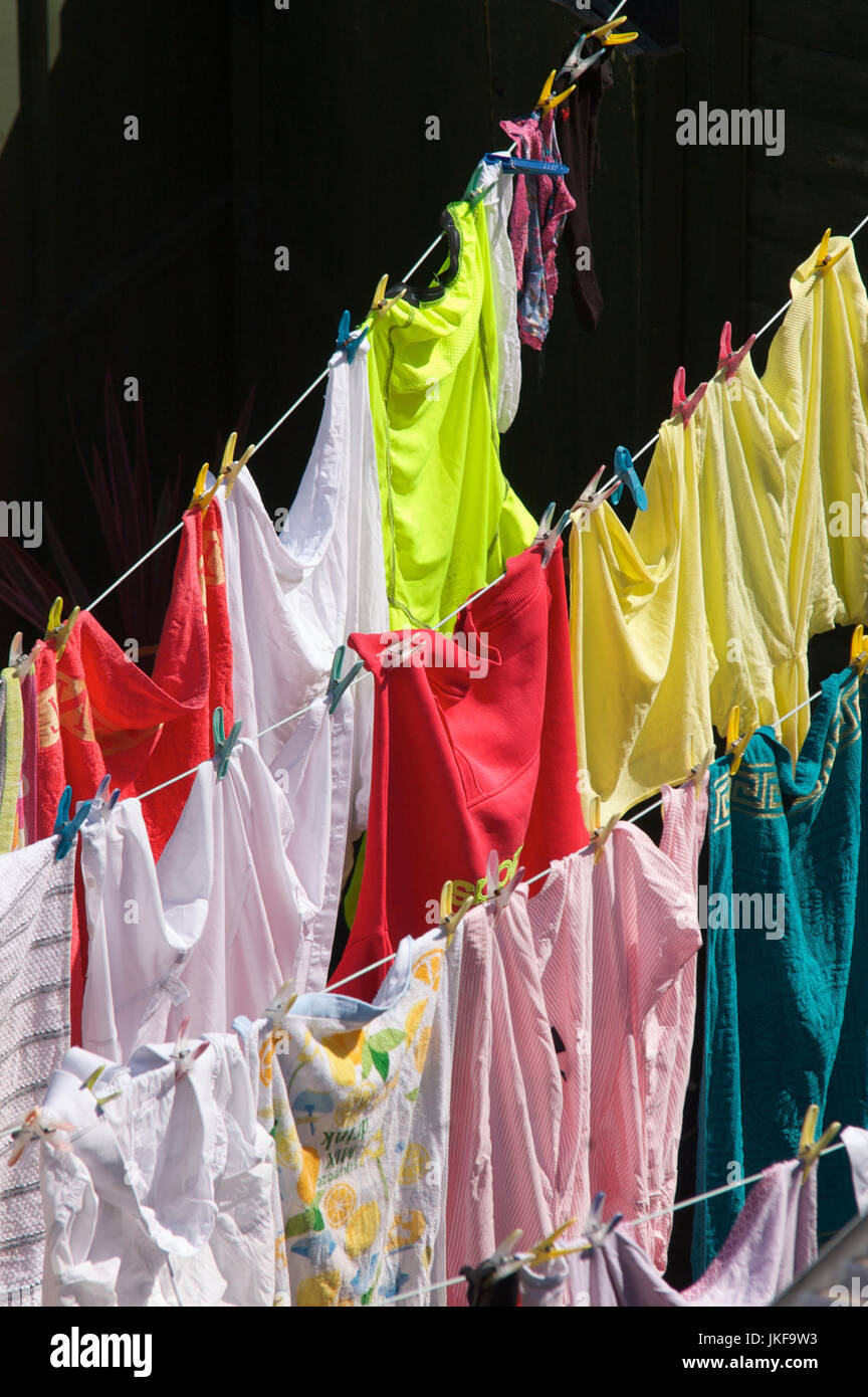 Washing hanging out to dry pegged on line Stock Photo
