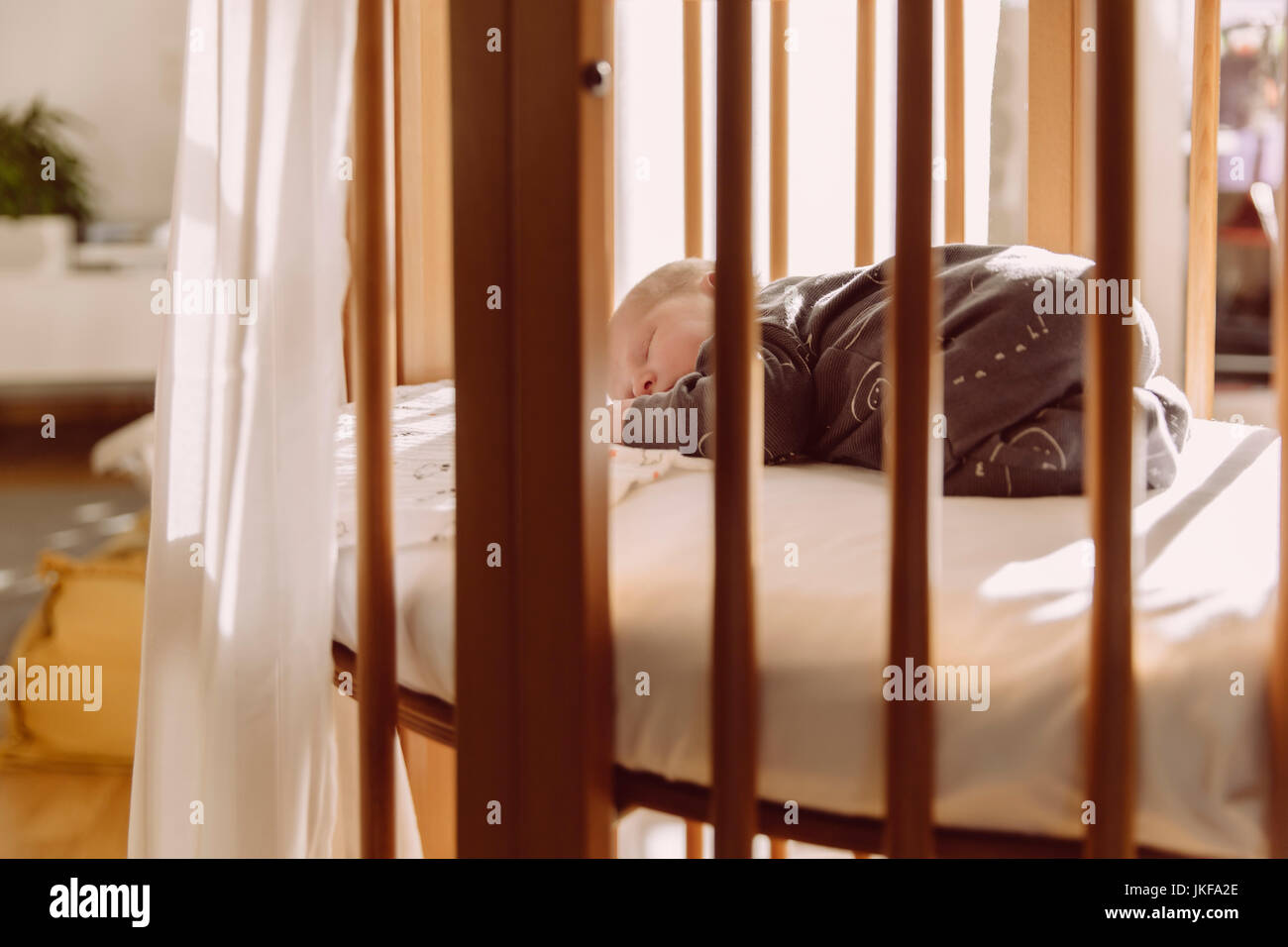 Newborn sleeping in his crib at home Stock Photo Alamy