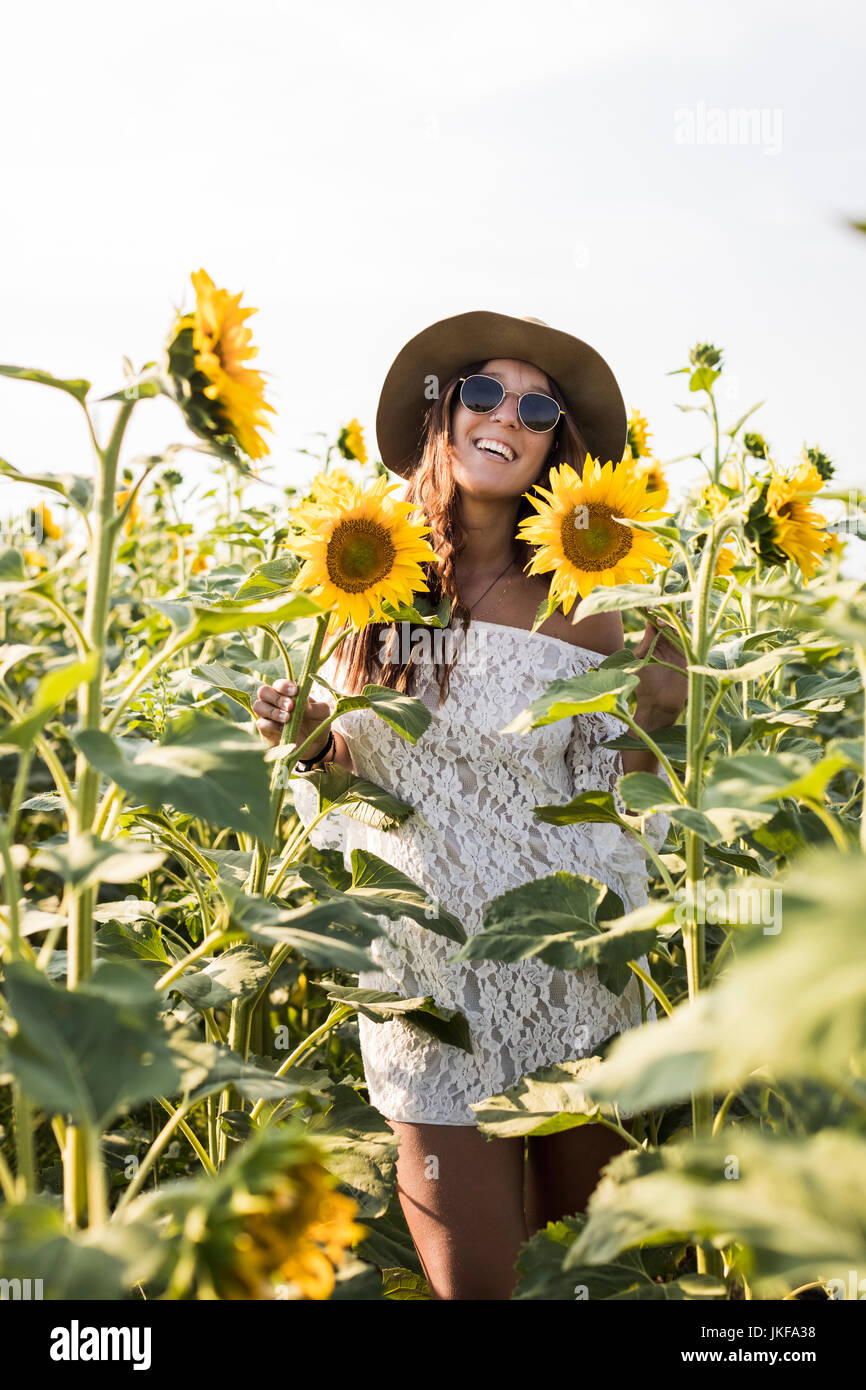 Beautiful Woman in a Sunflower Field Stock Photo - Alamy