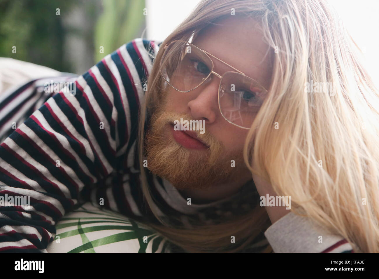Portrait Of Bearded Young Man With Long Blond Hair Wearing