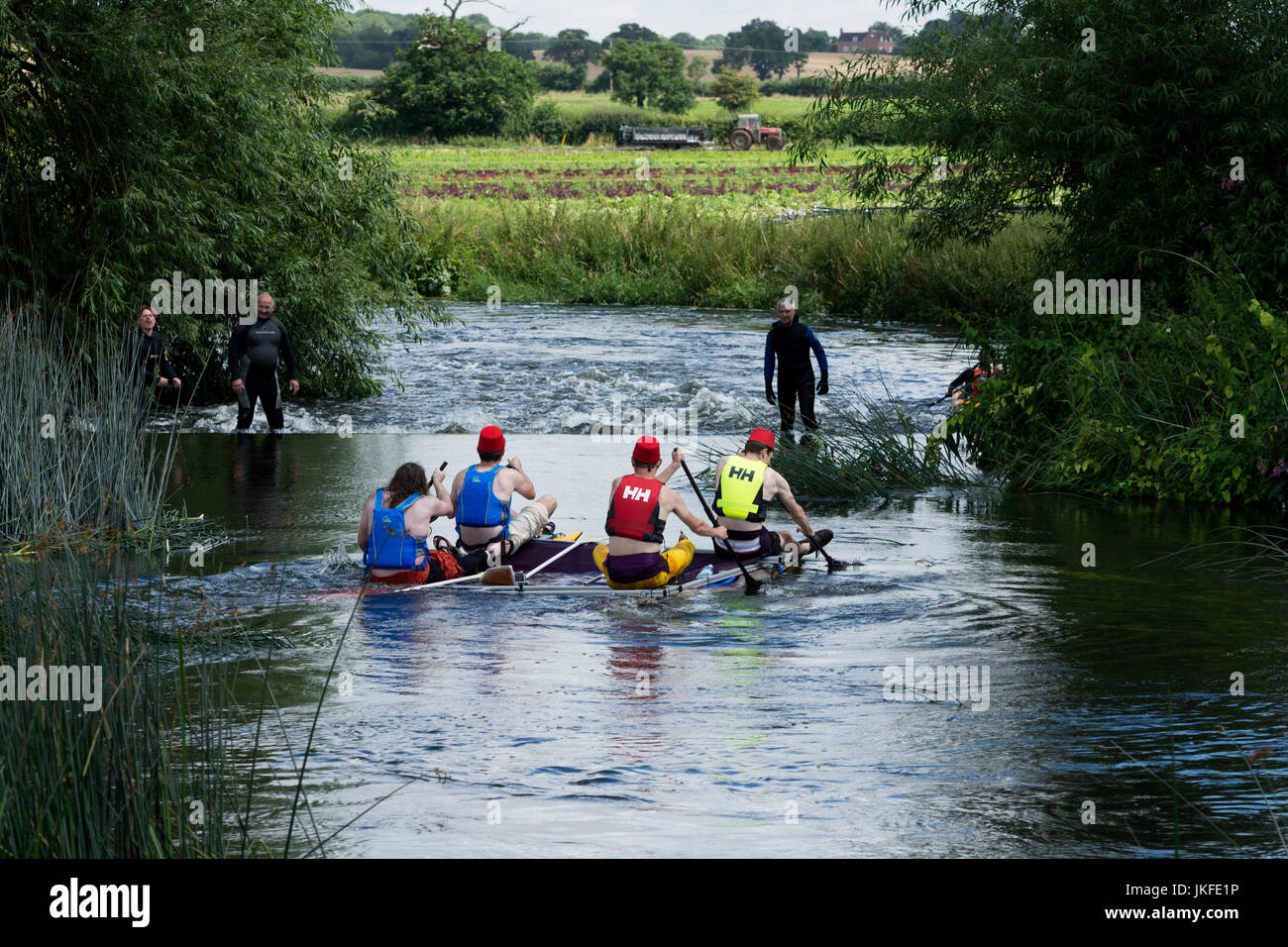 Alveston, Warwickshire, UK. 23rd July, 2017. Competitors approach Alveston Weir on the River Avon as part of the annual Wellesbourne and Stratford Lions Raft Race. The race passes through attractive Warwickshire countryside between the village of Wasperton and the town of Stratford-upon-Avon. Credit: Colin Underhill/Alamy Live News Stock Photo