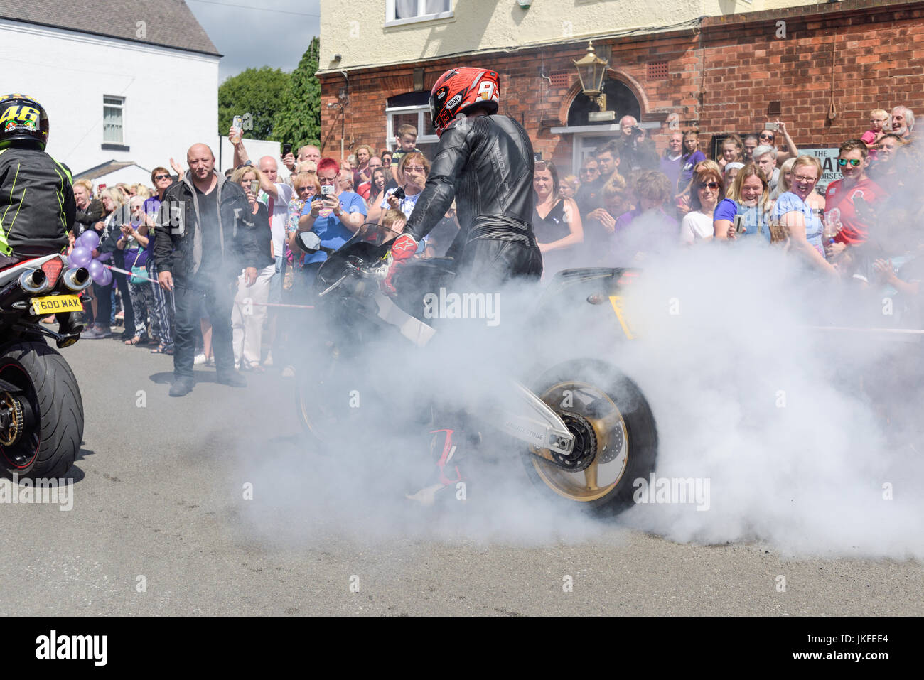 Beeston, Nottinghamshire, UK. 23rd July 2017. Nottinghamshire bikers’ group, Nottz Bikerz held a charity motorcycle run for Owen Jenkins.Owen drowned in the river Trent trying to save a young girl who was in trouble in the water.Thousands of motorcyclist turn up along with members of the public and Owens family members.Biker does burn-out in Owens honour. Credit: Ian Francis/Alamy Live News Stock Photo