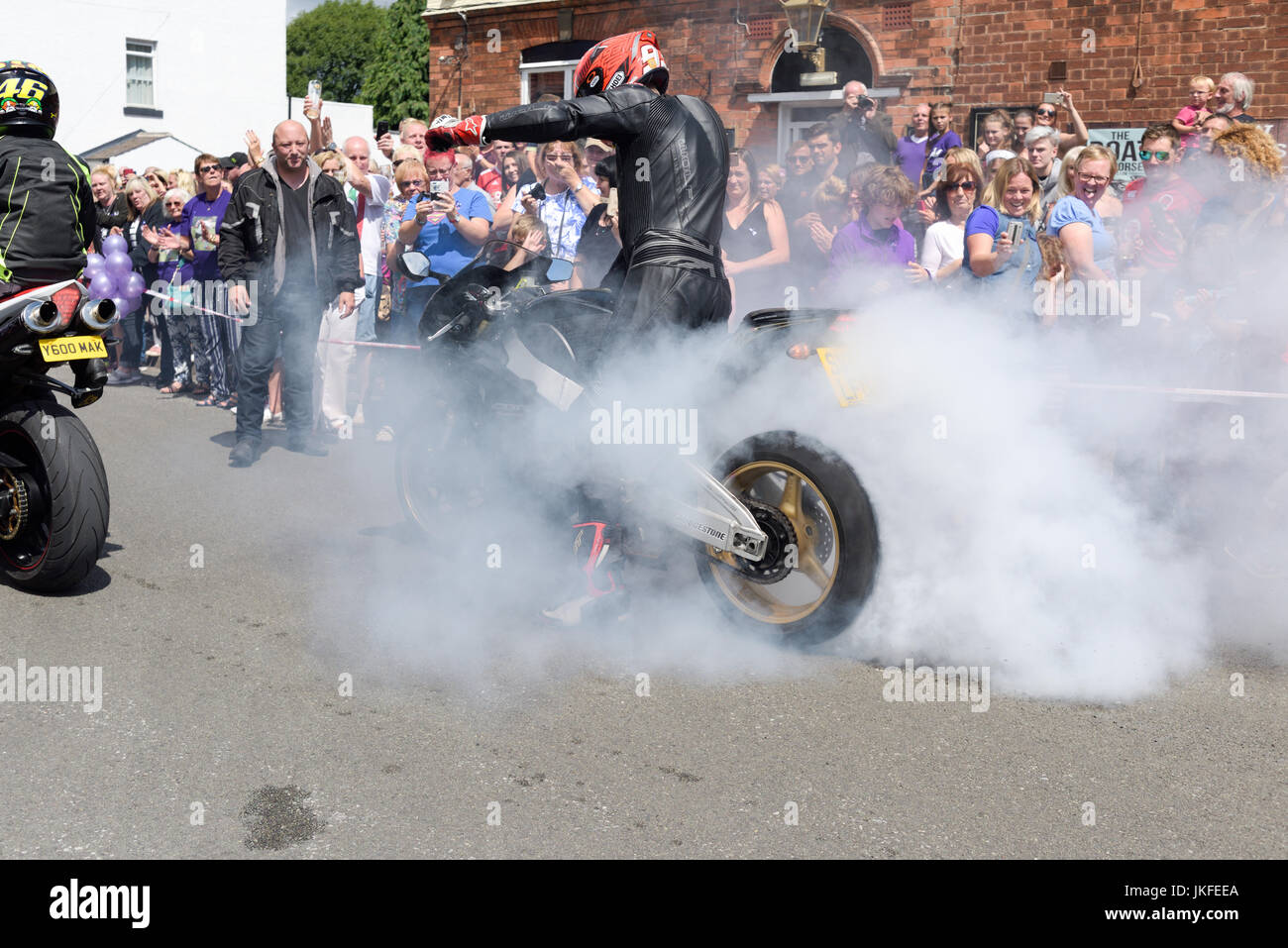 Beeston, Nottinghamshire, UK. 23rd July 2017. Nottinghamshire bikers’ group, Nottz Bikerz held a charity motorcycle run for Owen Jenkins.Owen drowned in the river Trent trying to save a young girl who was in trouble in the water.Thousands of motorcyclist turn up along with members of the public and Owens family members.Biker does burn-out in Owens honour. Credit: Ian Francis/Alamy Live News Stock Photo