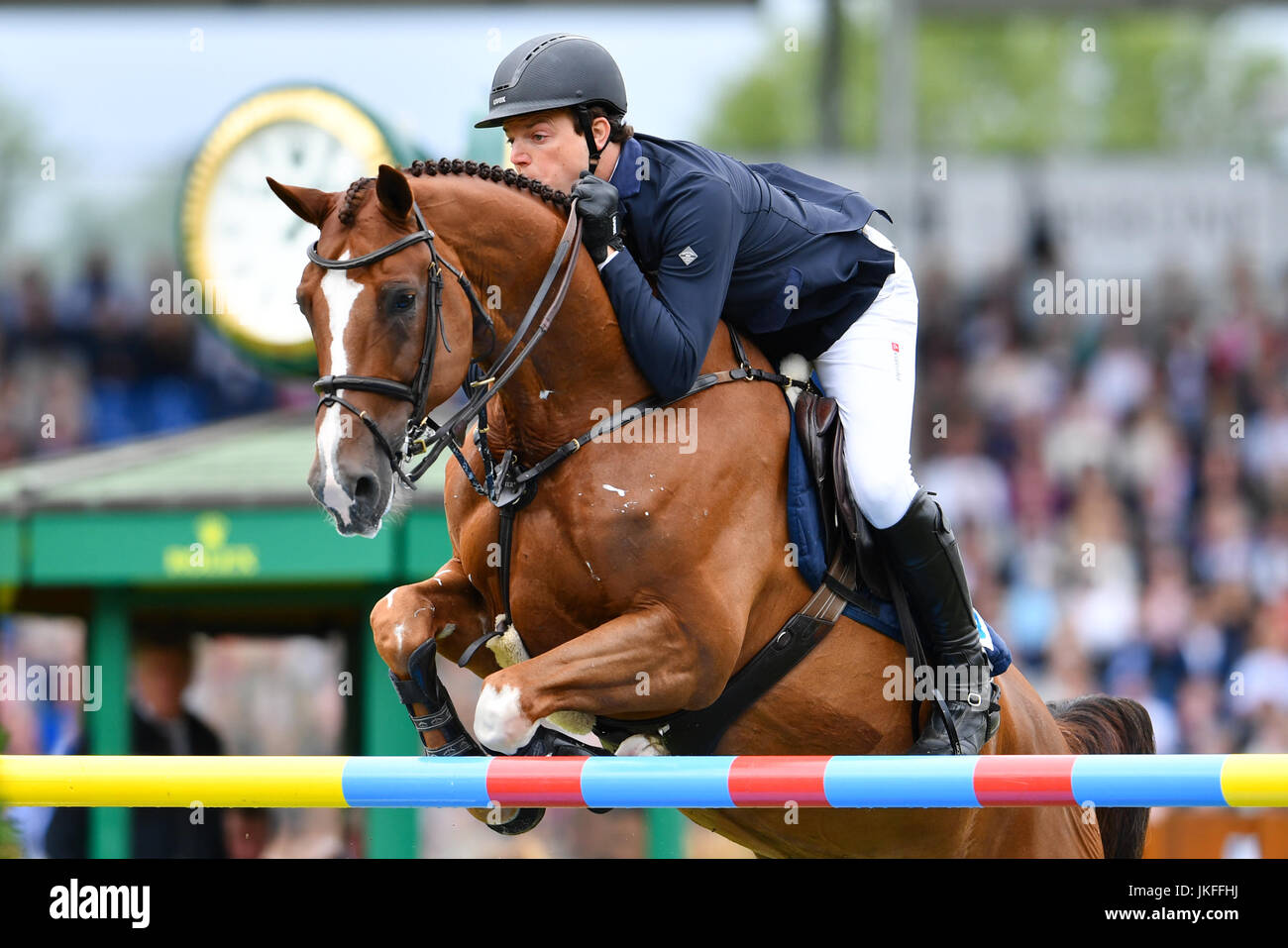 German show jumper Andreas Kreuzer jumping over an obstacle on his ...