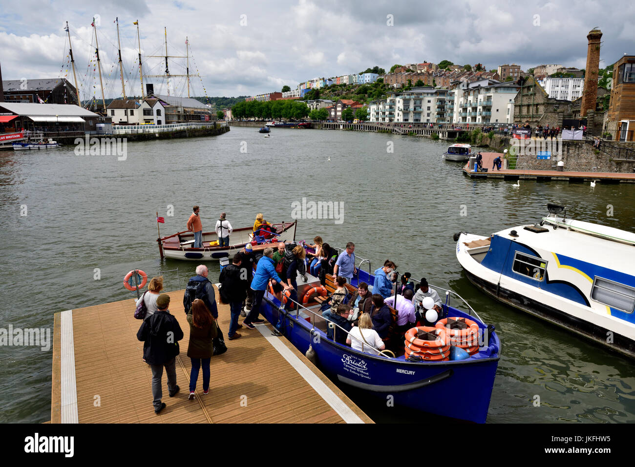 Bristol, UK. 23rd July, 2017. Rather mixed starting with heavy rain before the festival opened at 12:00 which then cleared to mixed sunshine and cloud. By 16:00 the forecasts were correct and a downpour commenced easing off at the official closing time for the festival. Some bright sun when these people were taking the cross harbour ferry. © Charles Stirling/Alamy Live News. Credit: Charles Stirling/Alamy Live News Stock Photo