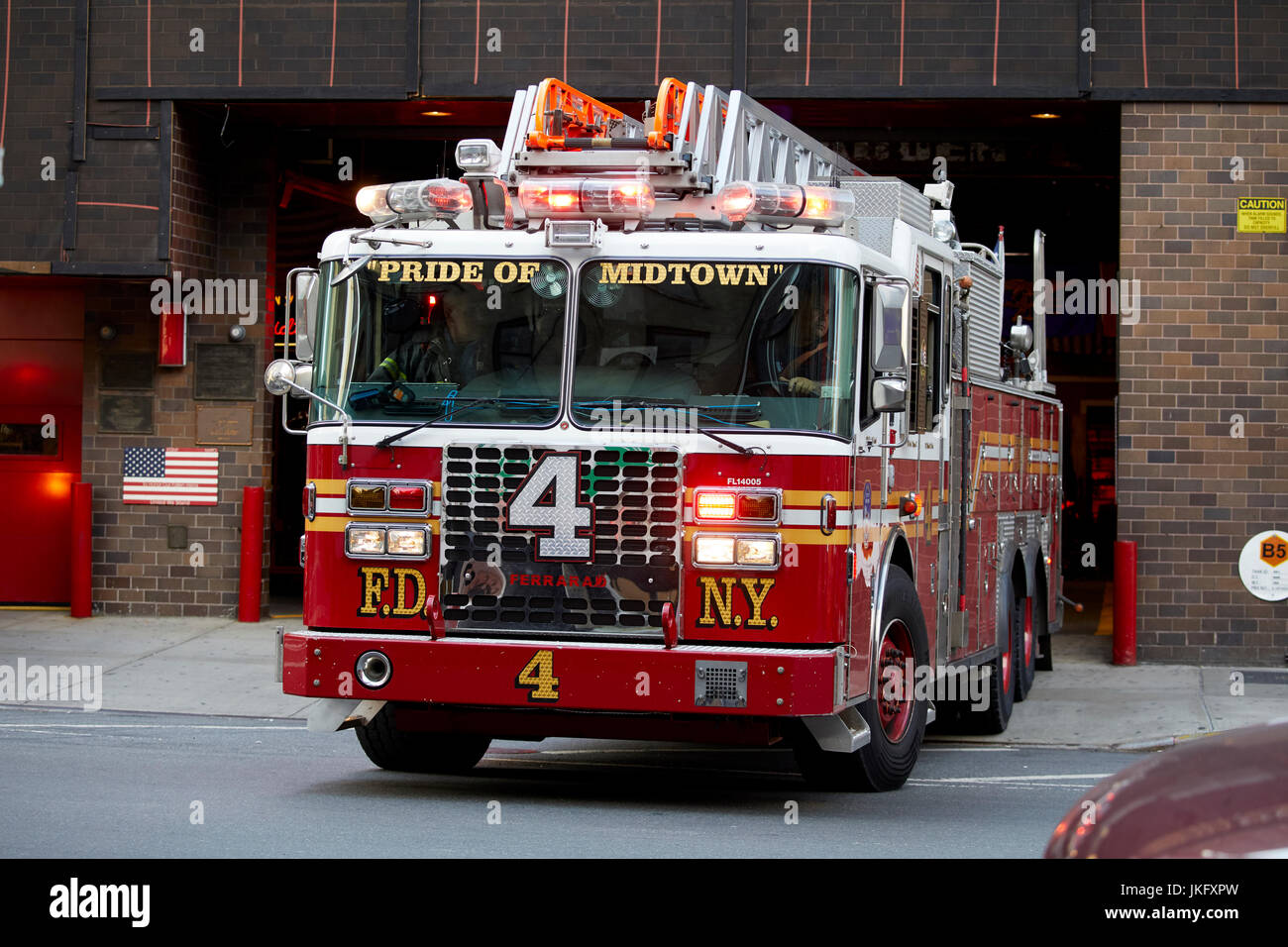 New York City, Manhattan, FDNY Pride of midtown Engine 54 Ladder 4 Battalion 9 on 8Th Avenue fire engine  leaving for an emergency fire Stock Photo