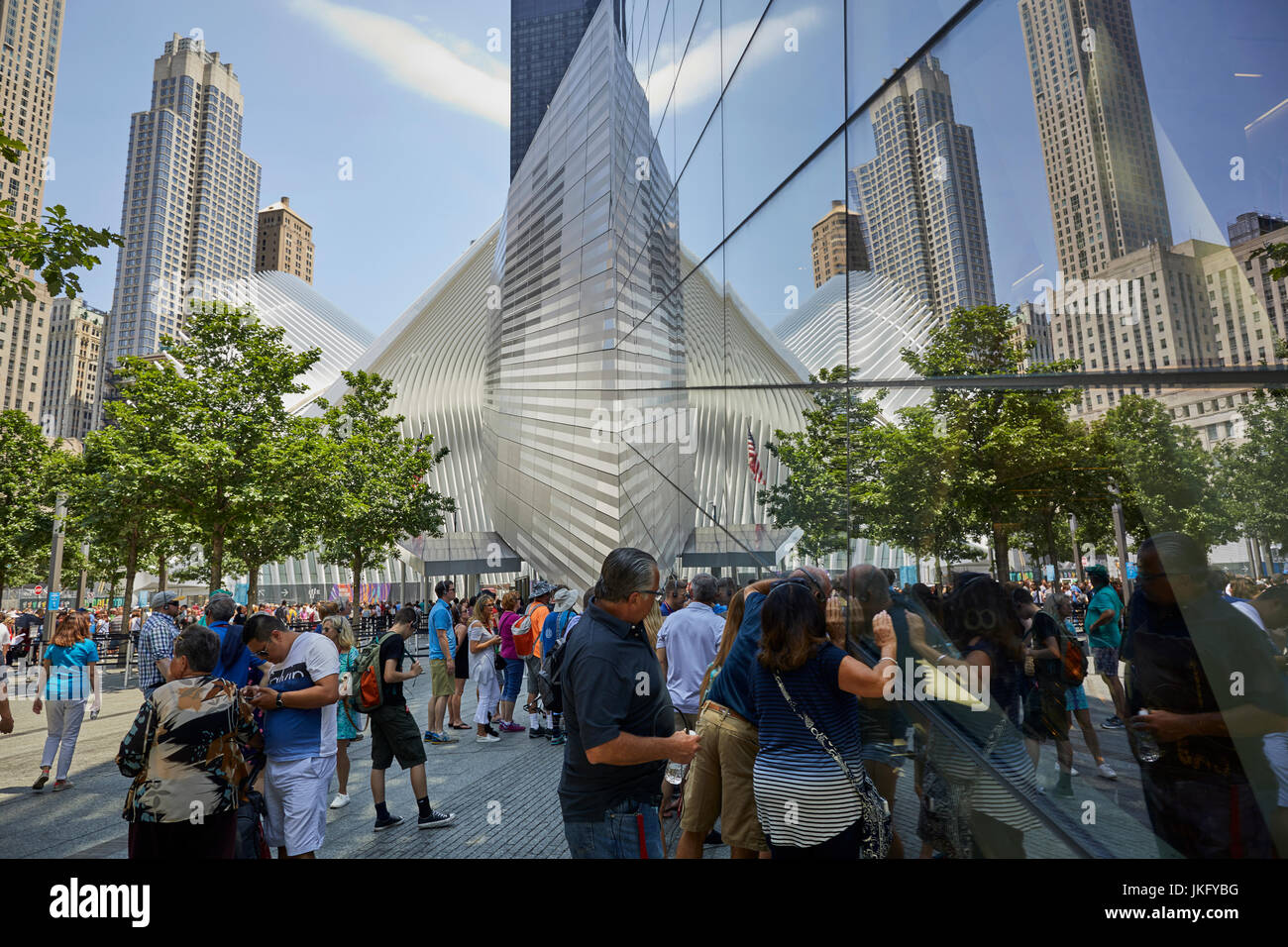 New York City, Manhattan, National September 11 Memorial & Museum, 9/11 Memorial tourist peeking through he windows as downtown building reflect in th Stock Photo