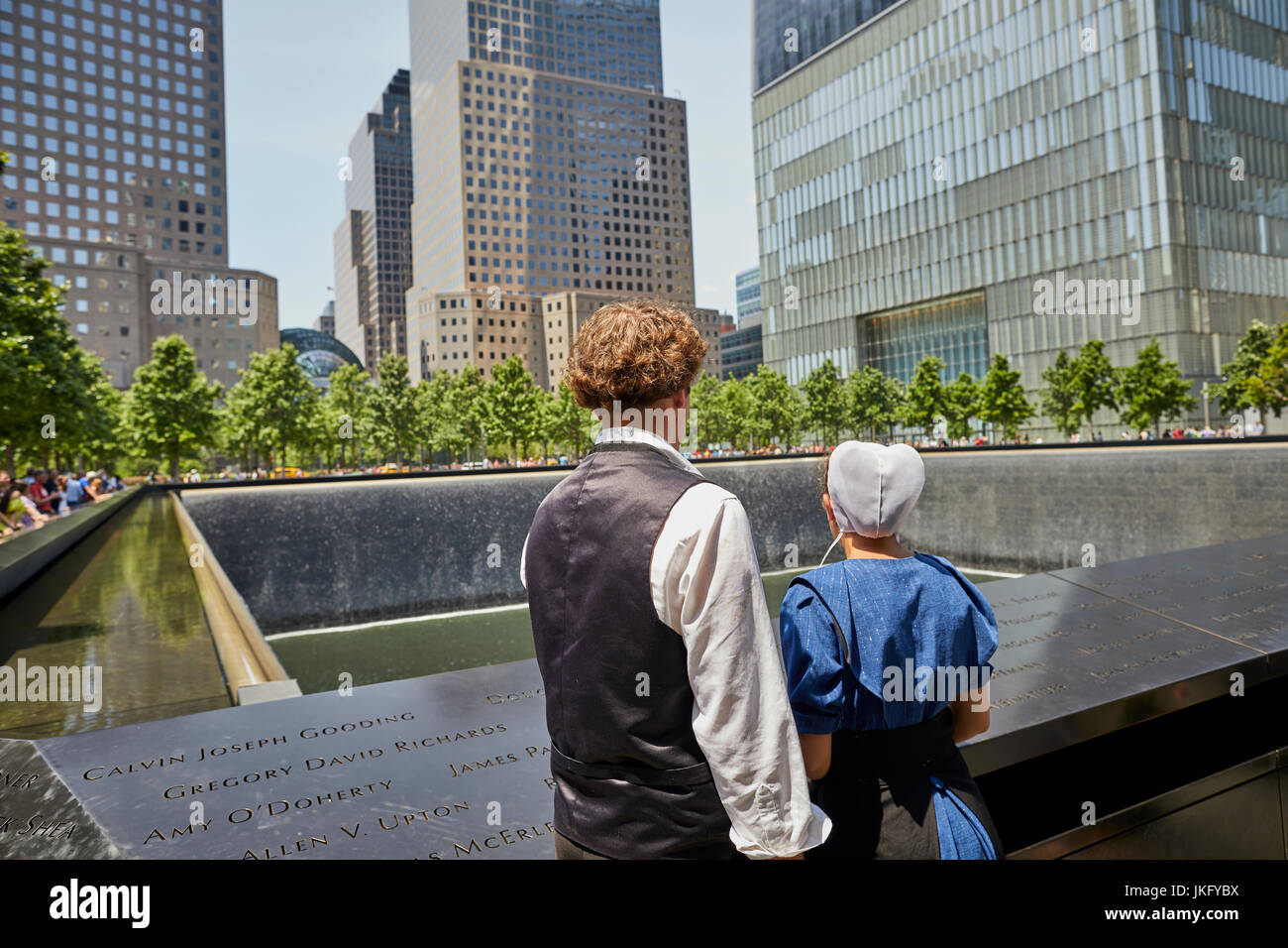 New York City, Manhattan, National September 11 Memorial & Museum, 9/11 Memorial fountains an Amish couple pay respect Stock Photo