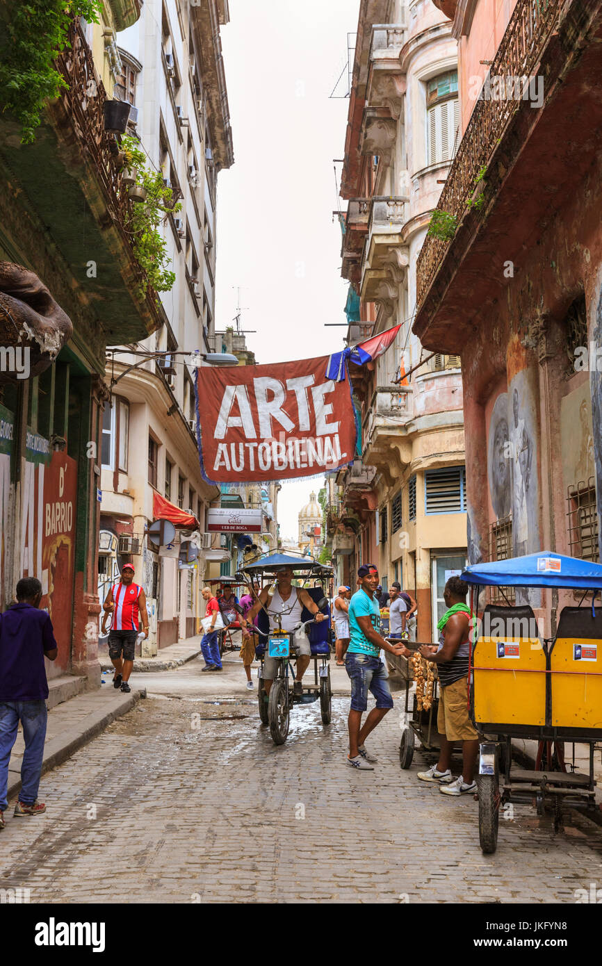 Gallery art studio and shops on O'Reilly and Villegas with Barrio del Arte banner from the Autobienal art exhibition, street scene, Old Havana, Cuba Stock Photo