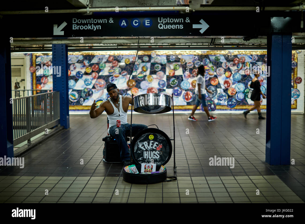 New York City, Manhattan, United States,   Times Square subway murals and a busker on the drums entertaining passengers Stock Photo
