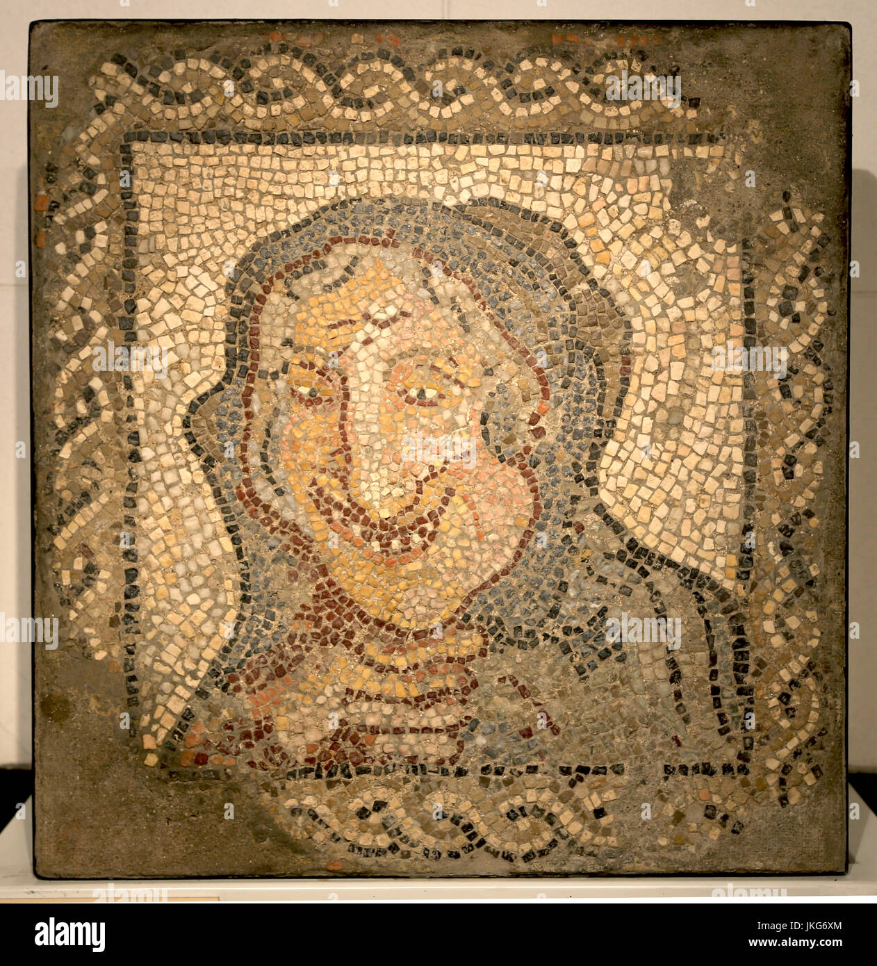 Mosaic representing an old woman. Roman culture,marble of different colors. 3rd Century AD. Italica, Sevilla, Spain. Stock Photo