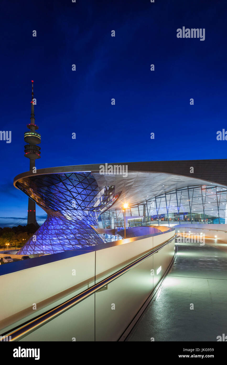 Germany, Bavaria, Munich, BMW Welt company showroom and Olympia Tower, dusk Stock Photo