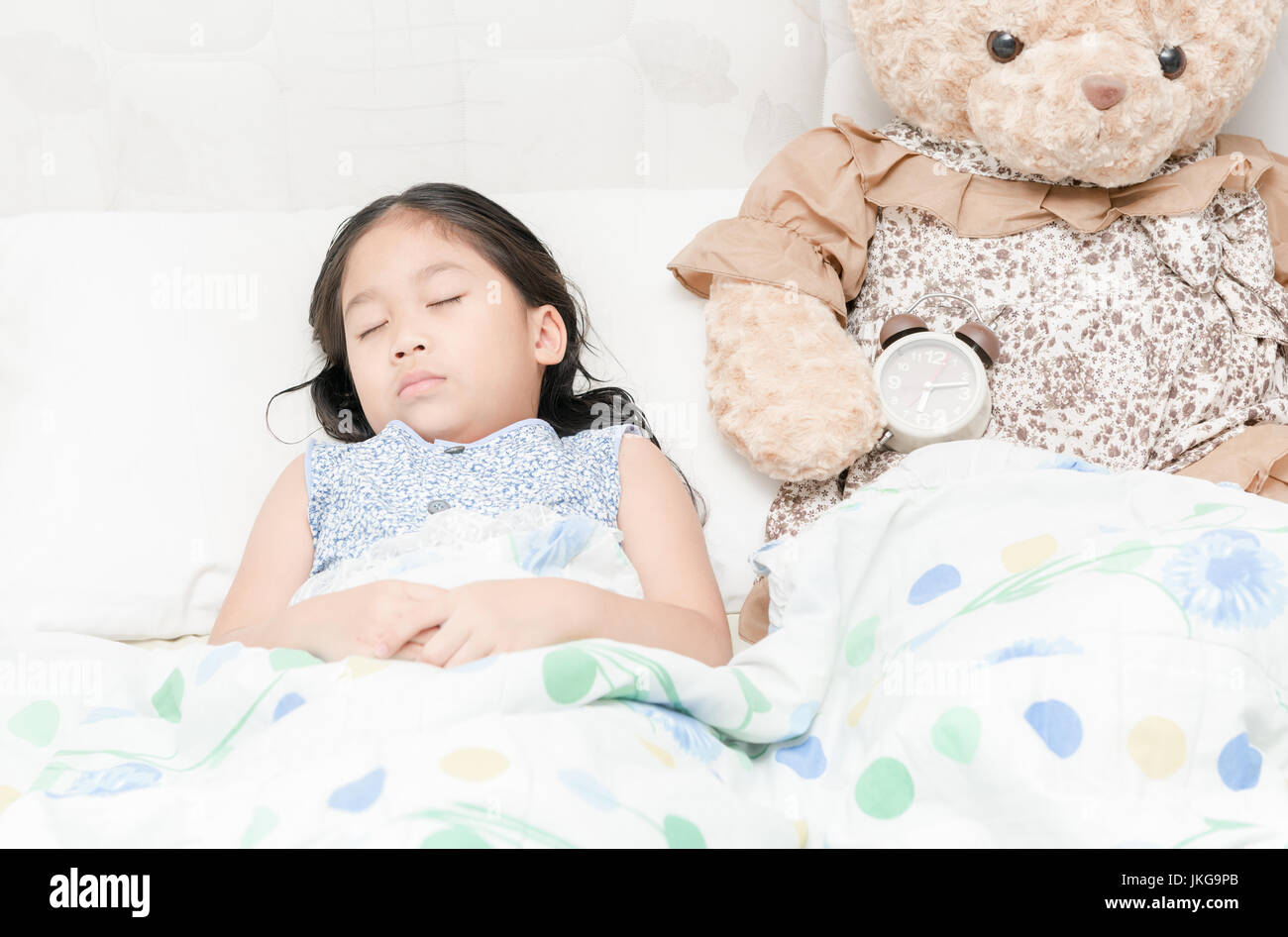 Adorable little girl sleeping in the bed with her teddy bear Stock ...