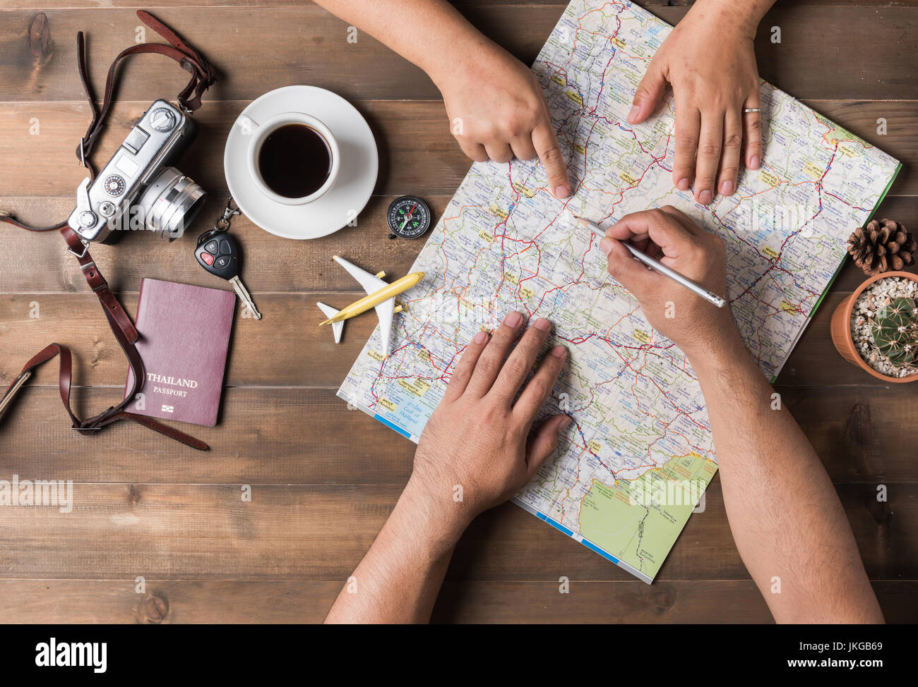 Young couple planning  vacation trip with map. Top view. Pointing to Thailand map Stock Photo