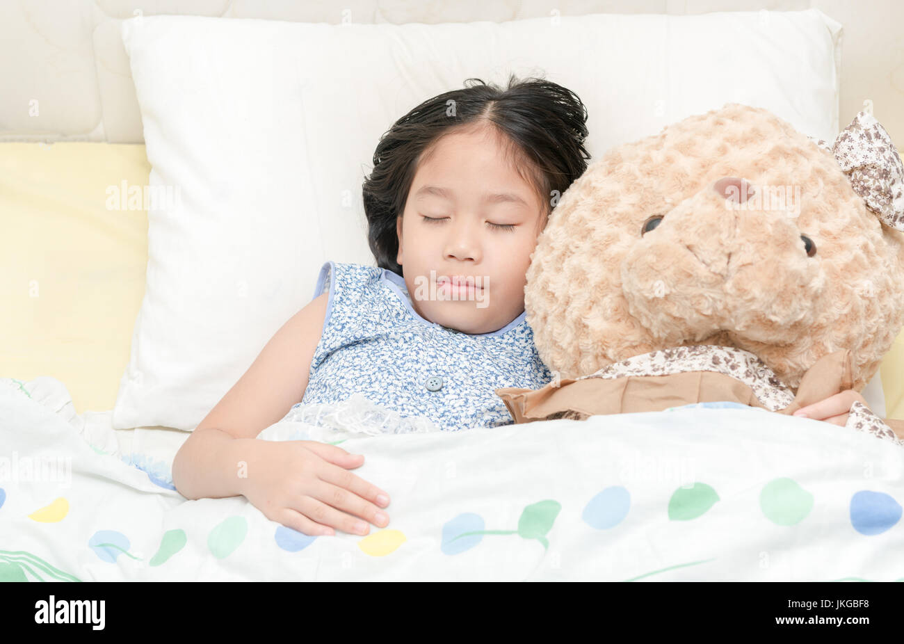 Adorable little girl sleeping in the bed with her teddy bear Stock ...