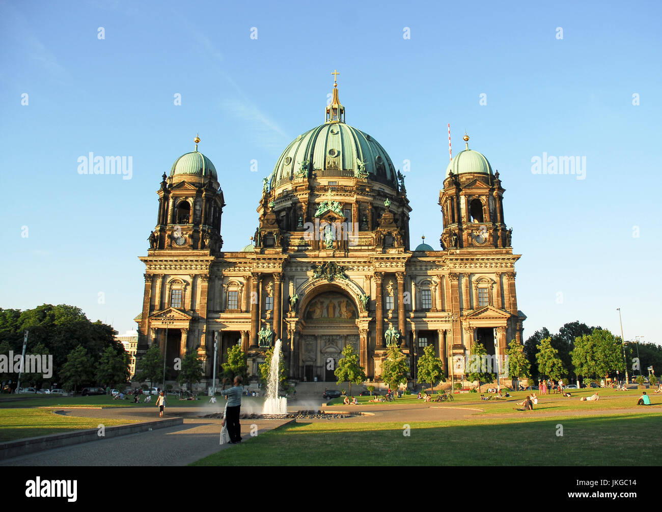 BERLIN-MAY 30 : The Berlin cathedral with unidentified people outside,walking or lying in the grass,Berlin Mitte district,Germany,on May 30,2011. Stock Photo