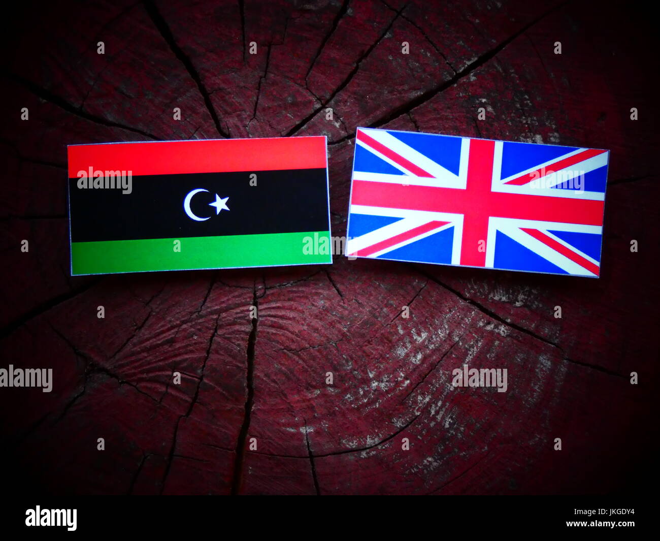 Libyan flag with UK flag on a tree stump isolated Stock Photo