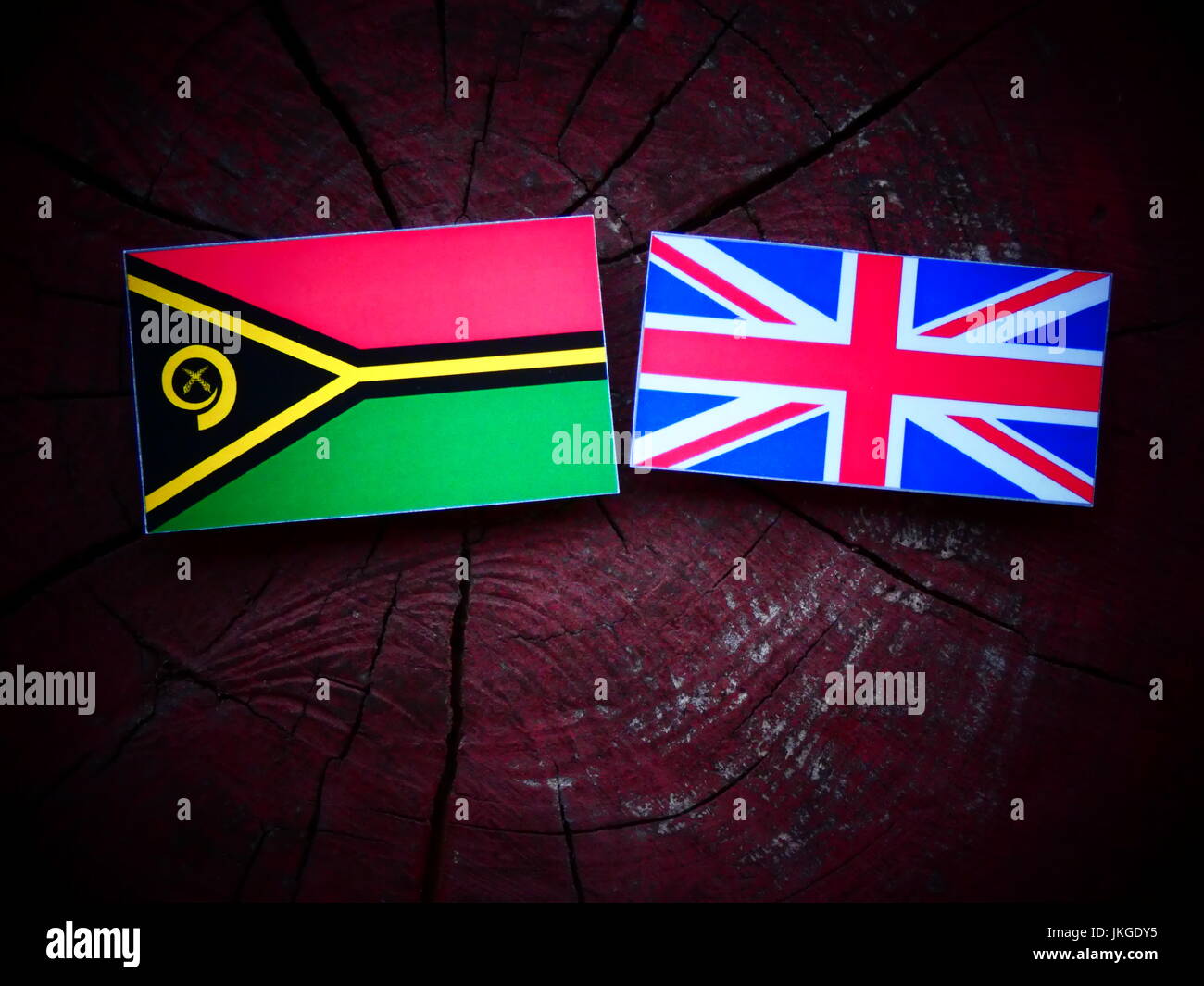 Vanuatu flag with UK flag on a tree stump isolated Stock Photo