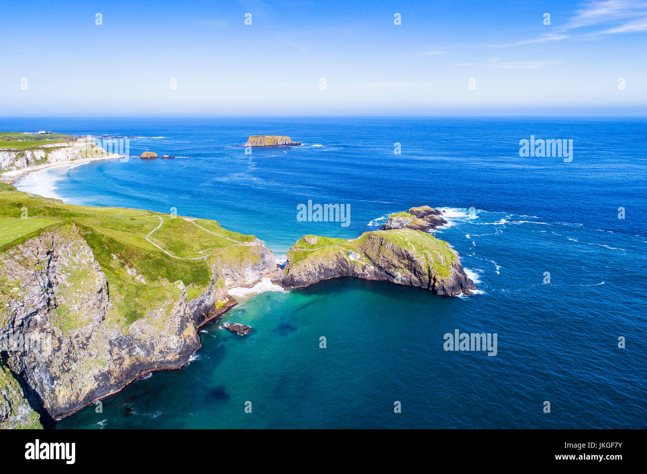 Carrick-a-Rede Rope Bridge, National Trust. on the Causeway Coast in Antrim County, Northern Ireland, UK. Far aerial view with cliffs and Sheep Island Stock Photo