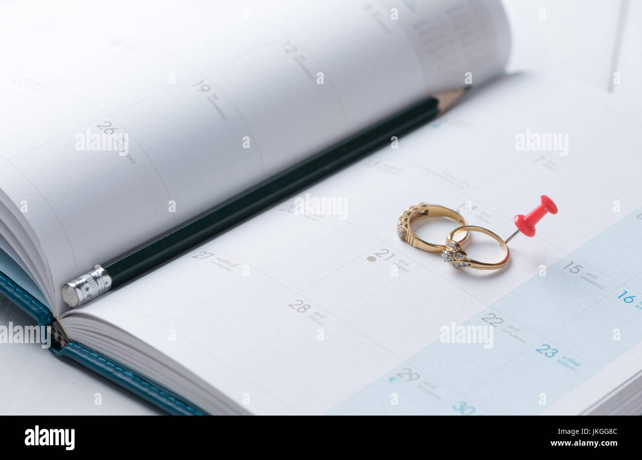 Wedding gold rings on calender (14 February) with pencil, Valentine's day concept. Stock Photo