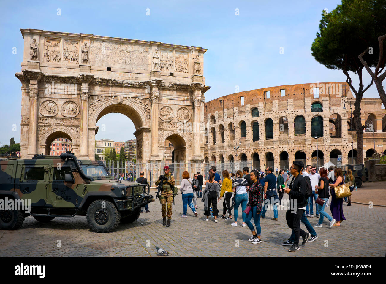 Horizontal view of the Arch of Constantine and the Colosseum heavily guarded by soldiers in Rome. Stock Photo