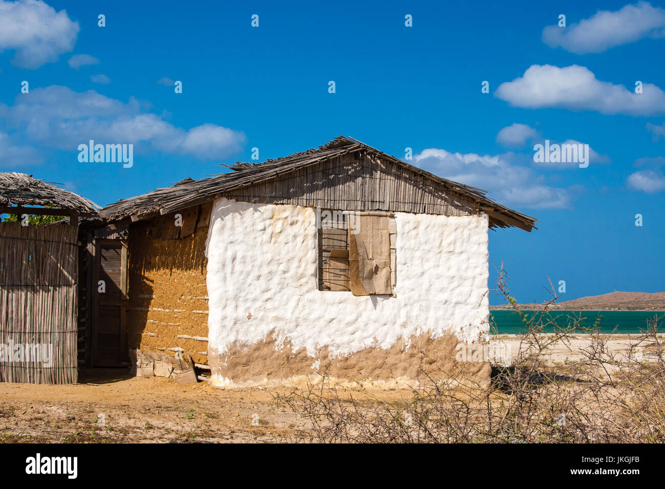 Traditional adobe house next to the sea under blue sky Stock Photo