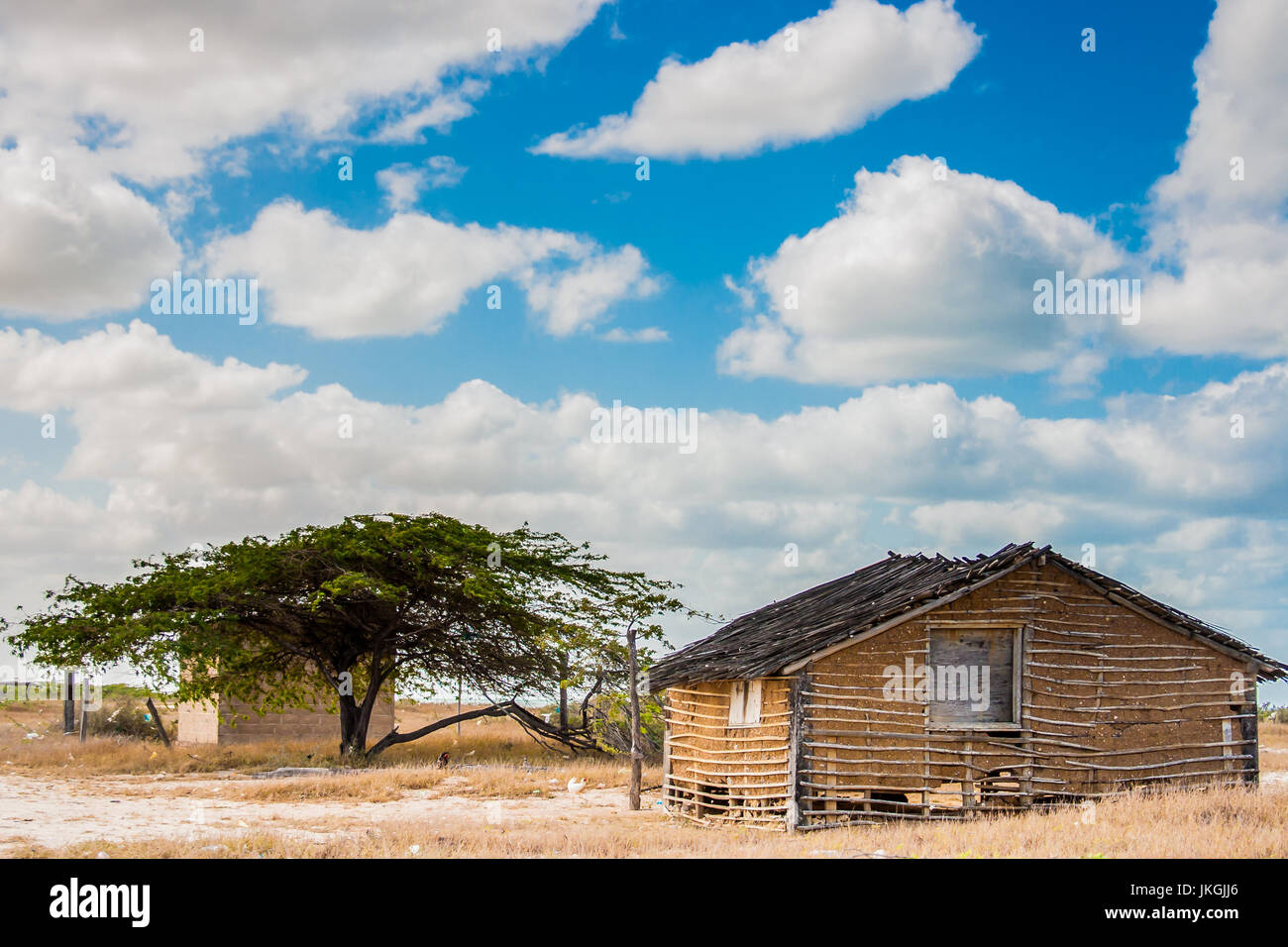 Traditional adobe house on the desert under blue sky Stock Photo