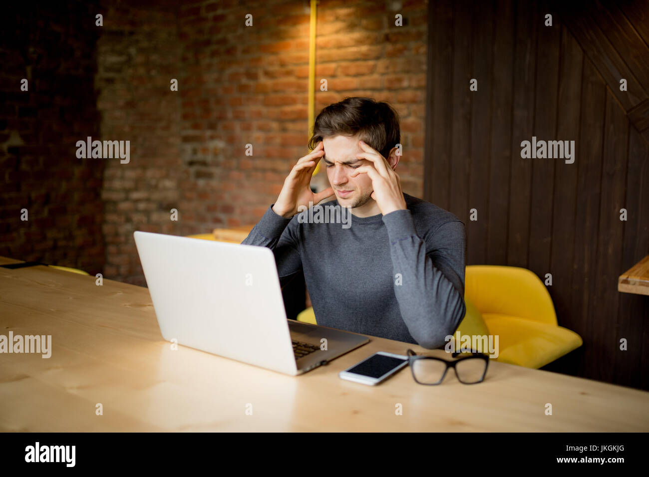 Handsome Man Working At Laptop With Sad Face Or Head Ache Working At handsome-man-working-at-laptop-with-sad-face-or-head-ache-working-at