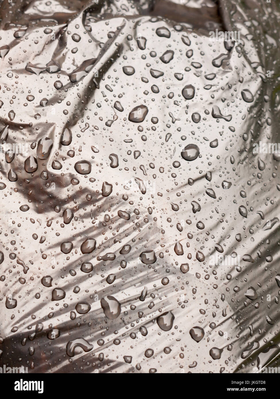 water close drops up on a black bin bag; Essex; UK Stock Photo