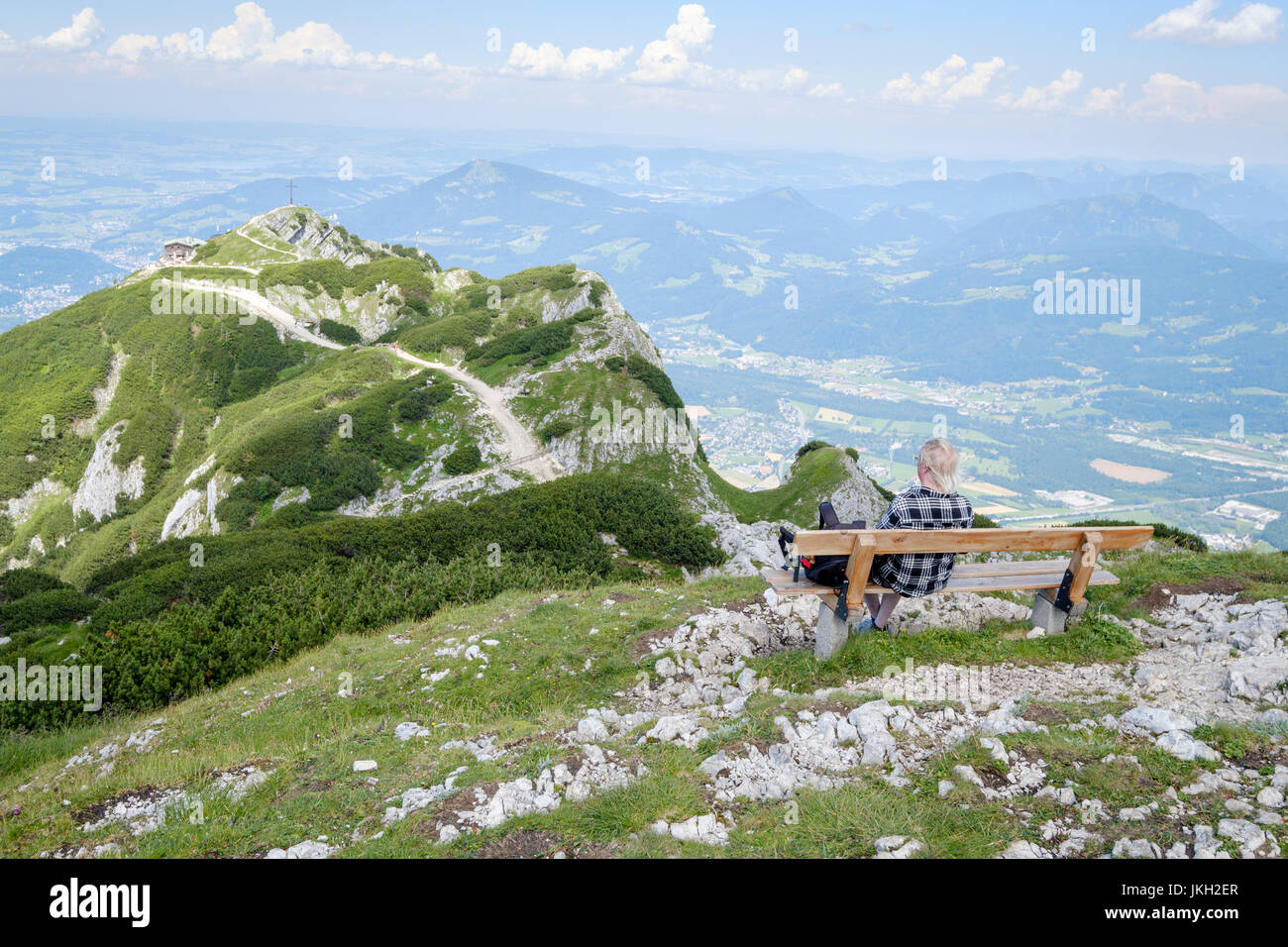 Hiker enjoying the view from the Salzburger Hochthron to Geiereck mountain peak, the Hochalm Restaurant and the Salzach Valley, Grödig, Salzburg-Umgeb Stock Photo