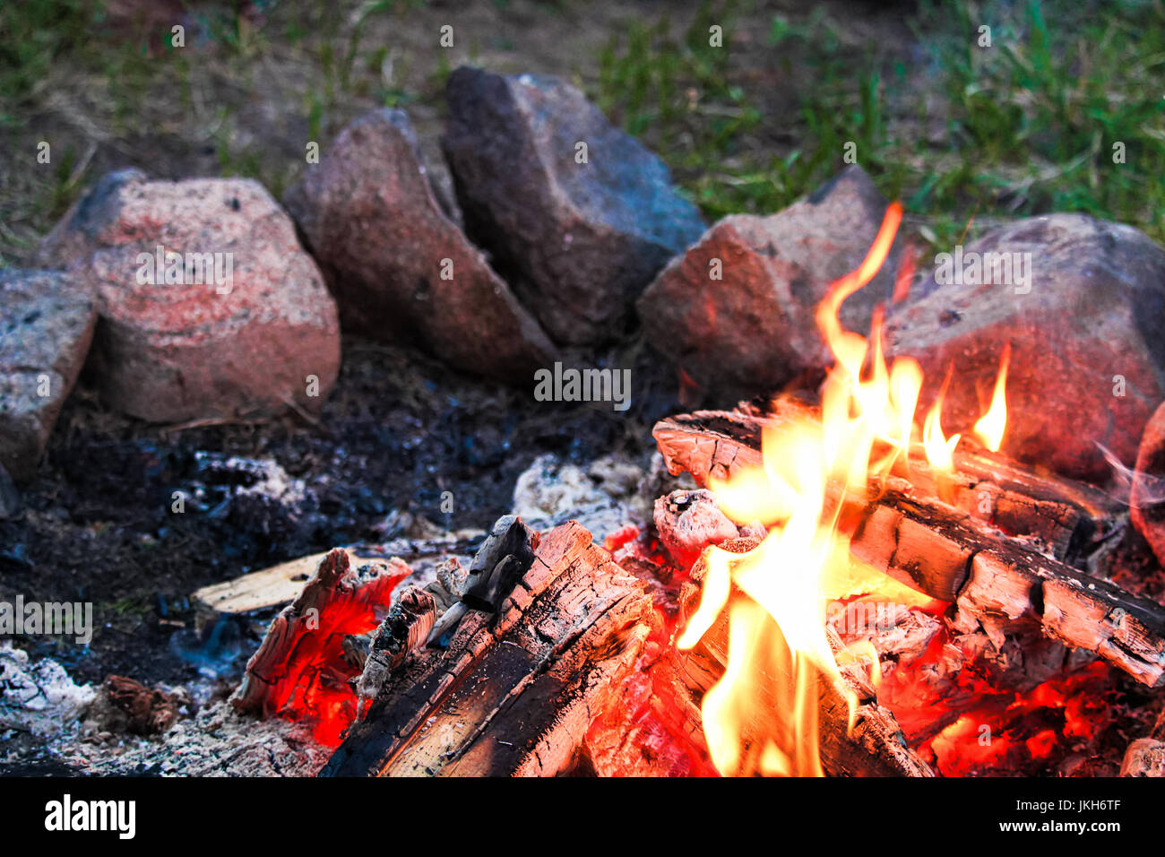 A campfire with a ring of stones around it Stock Photo - Alamy