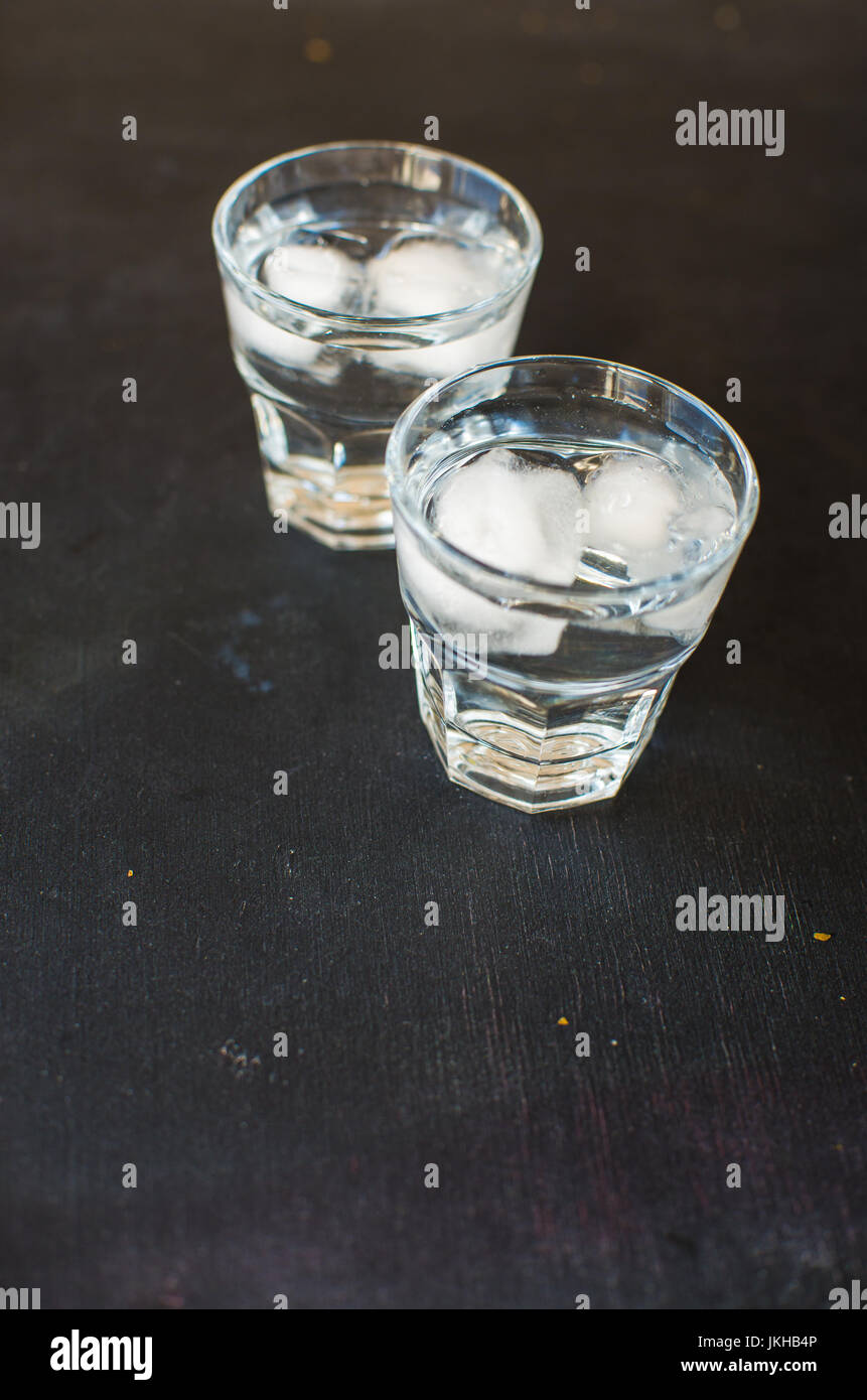 Summer drink glass of water with ice on dark background Stock Photo - Alamy