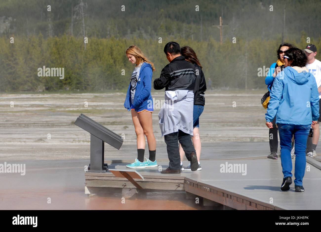 Visitors reading a plaque at Grand Prismatic spring, Yellowstone National Park Stock Photo