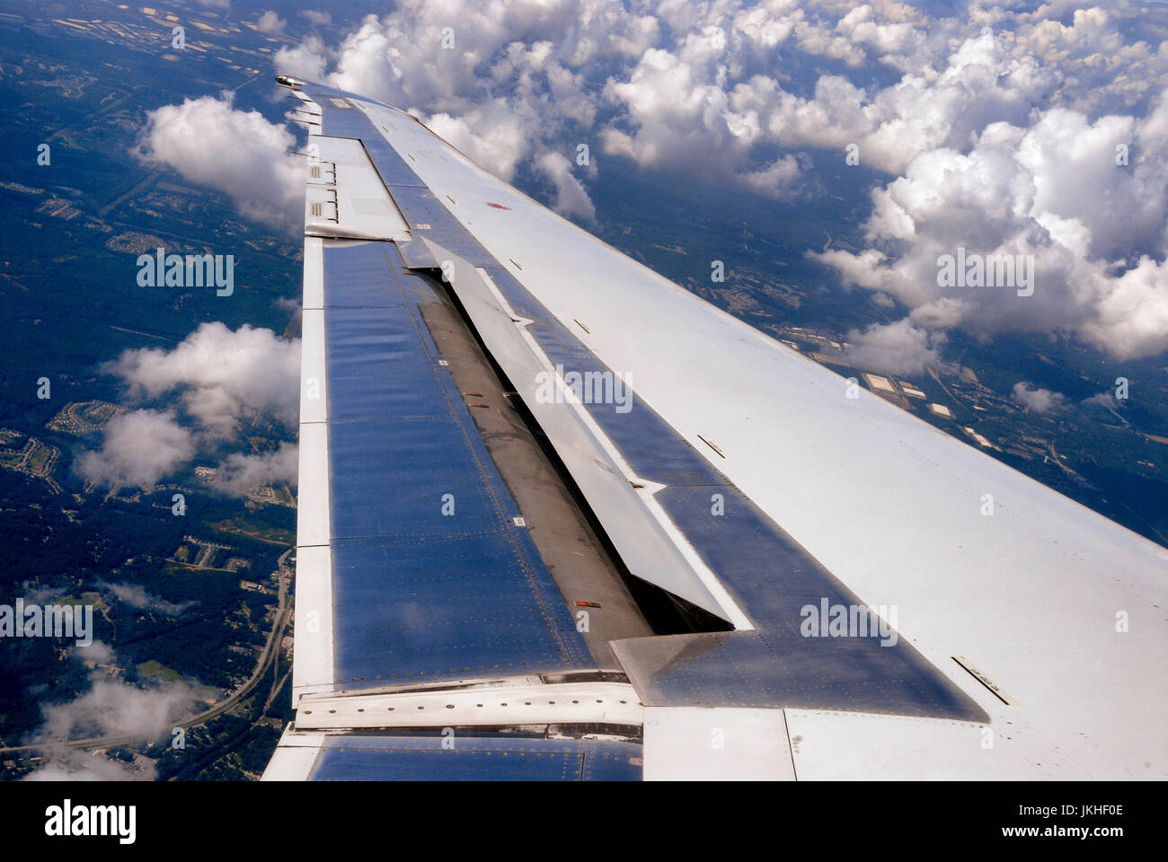 Aileron of a airplane wing during flight Stock Photo