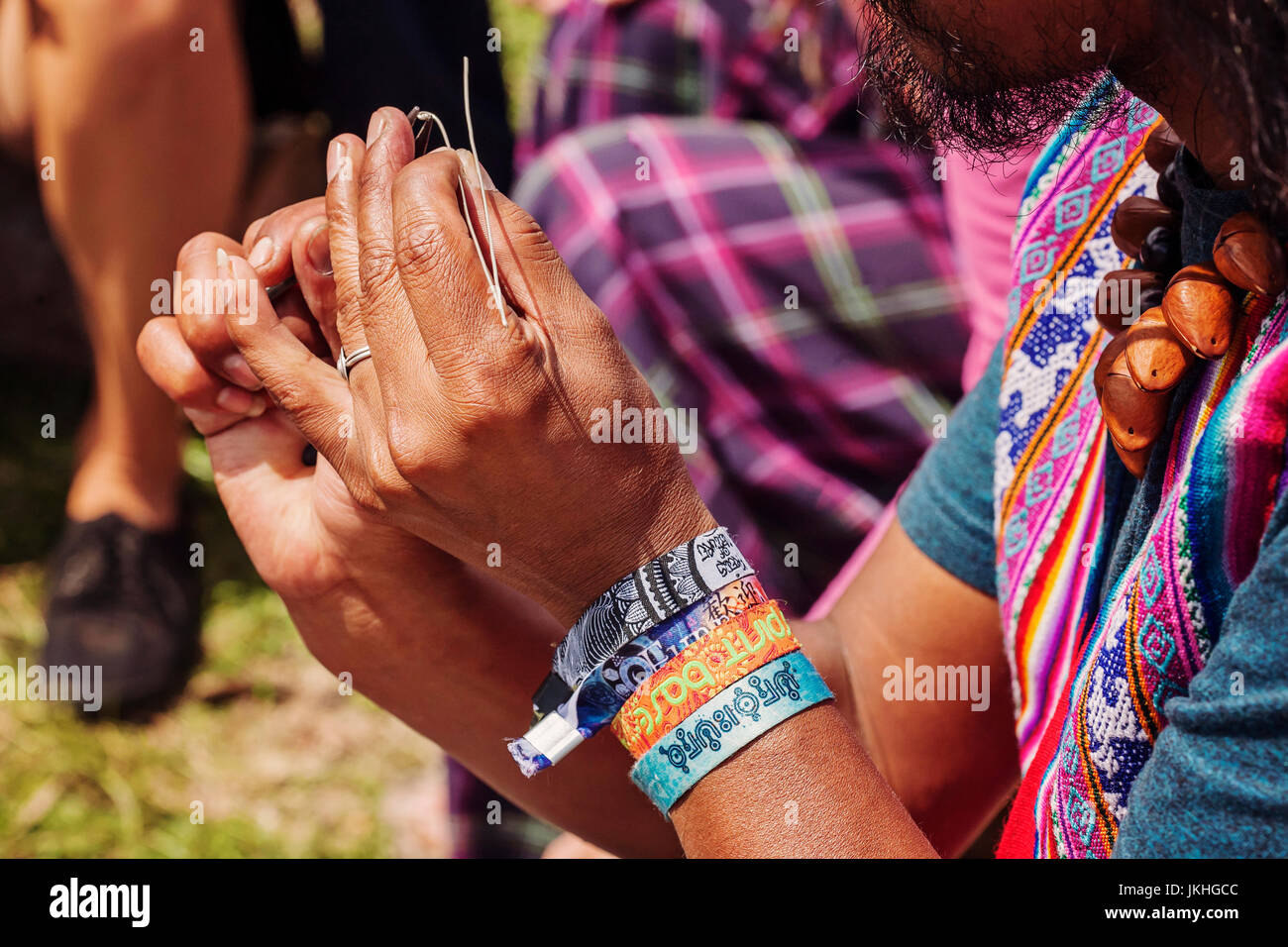 Peruvian jewelry artist making a ring from alpaca metal string ...