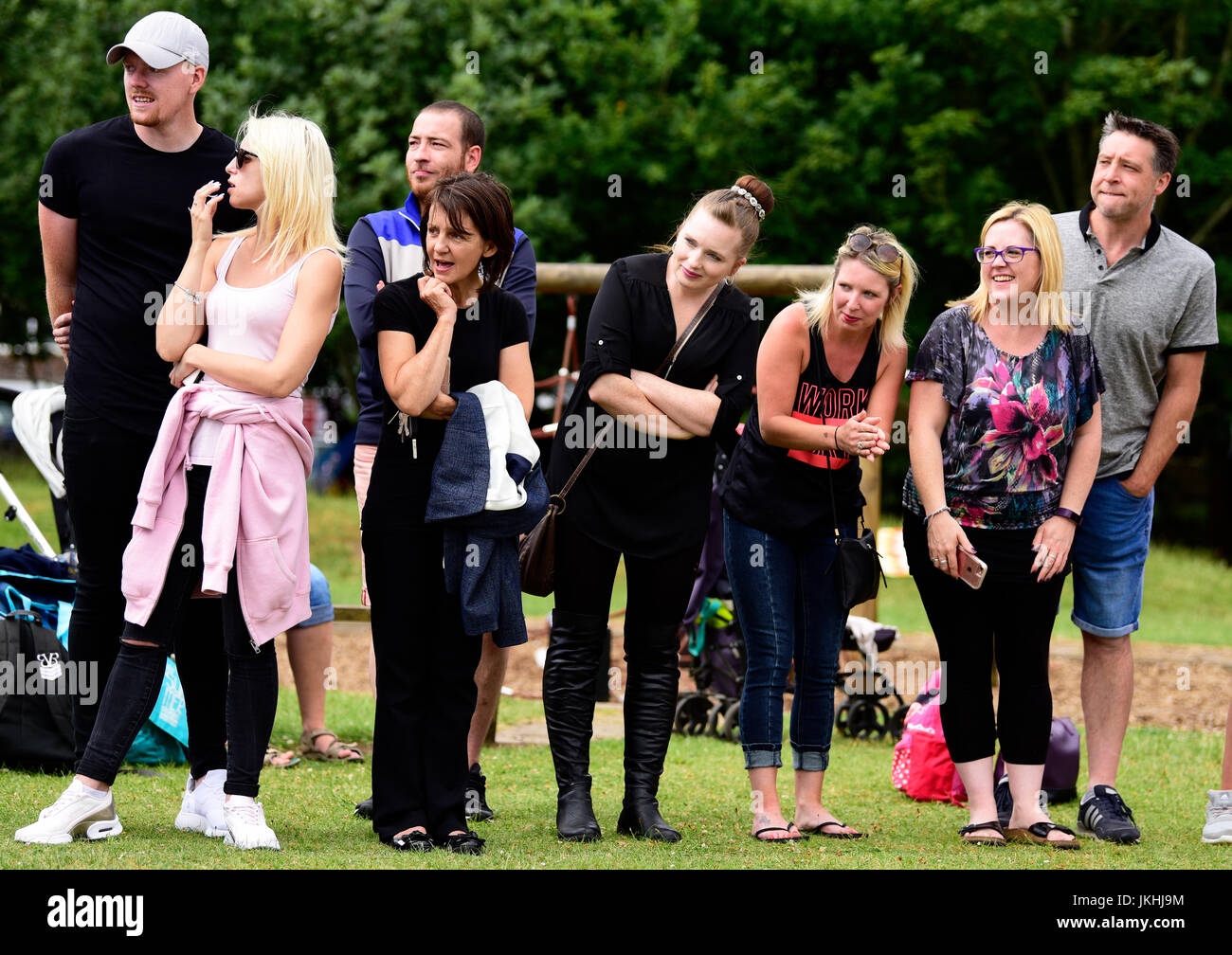 Parents watching their kids run at an infants school sports day, Bordon, Hampshire, UK. 14 July 2017. Stock Photo