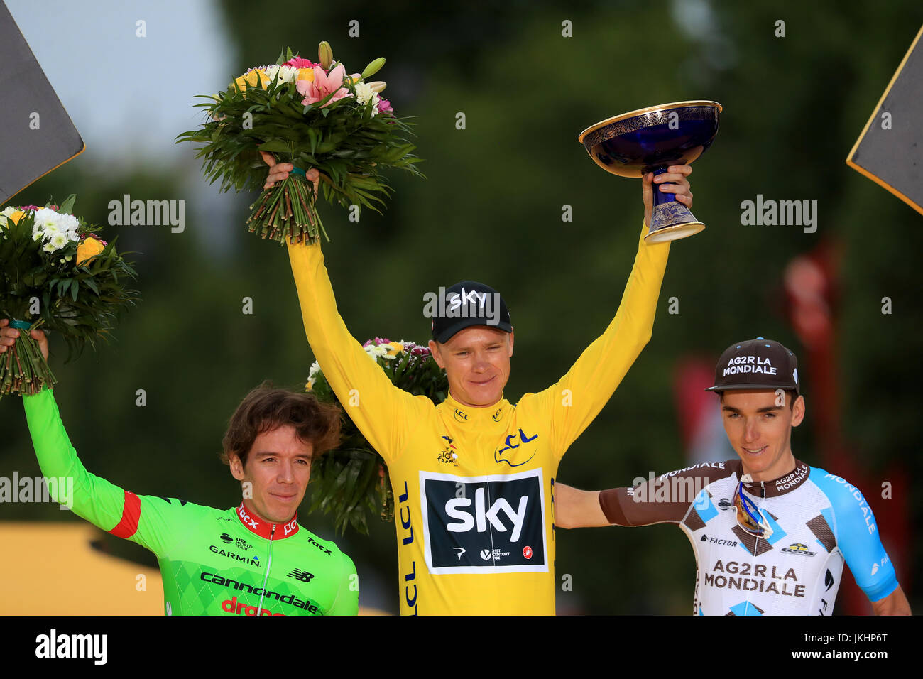 Team Sky's Chris Froome (centre) celebrates victory on the podium next to second place Cannondale's Rigoberto Uran (left) and third place AG2R La Mondiale's Romain Bardet (right) after stage 21 of the Tour de France in Paris, France. Stock Photo