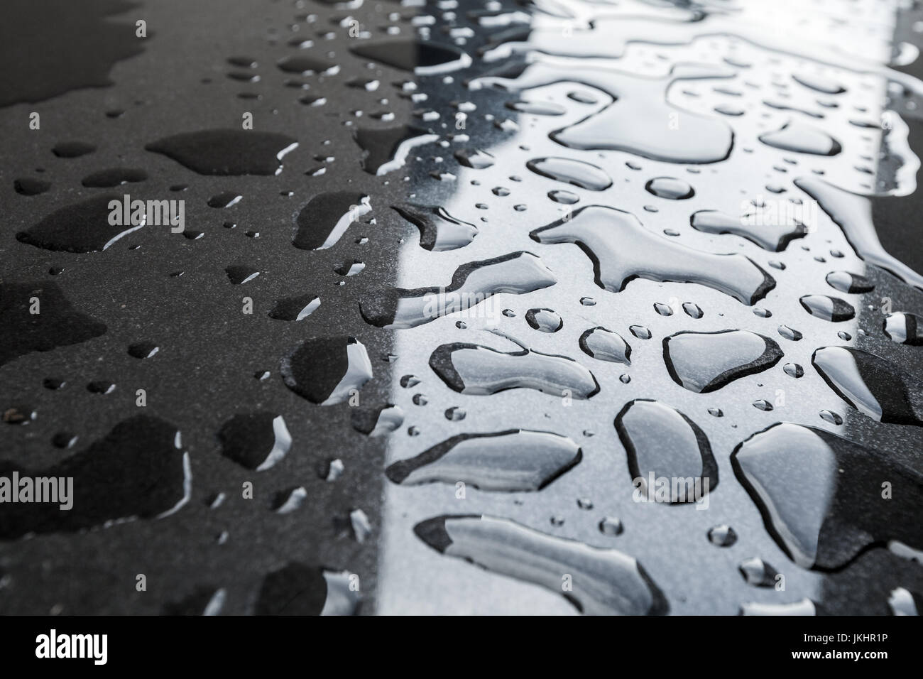 Wet black stone floor, closeup photo with selective focus Stock Photo