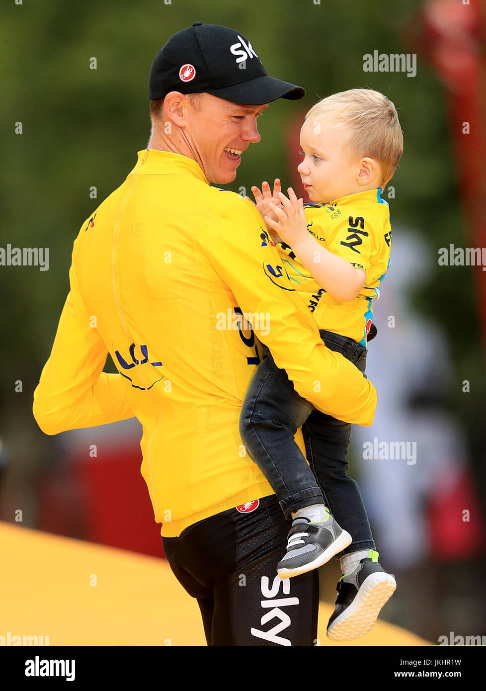 Team Sky's Chris Froome celebrates with his son Kellan after stage 21 of the Tour de France in Paris, France. Stock Photo