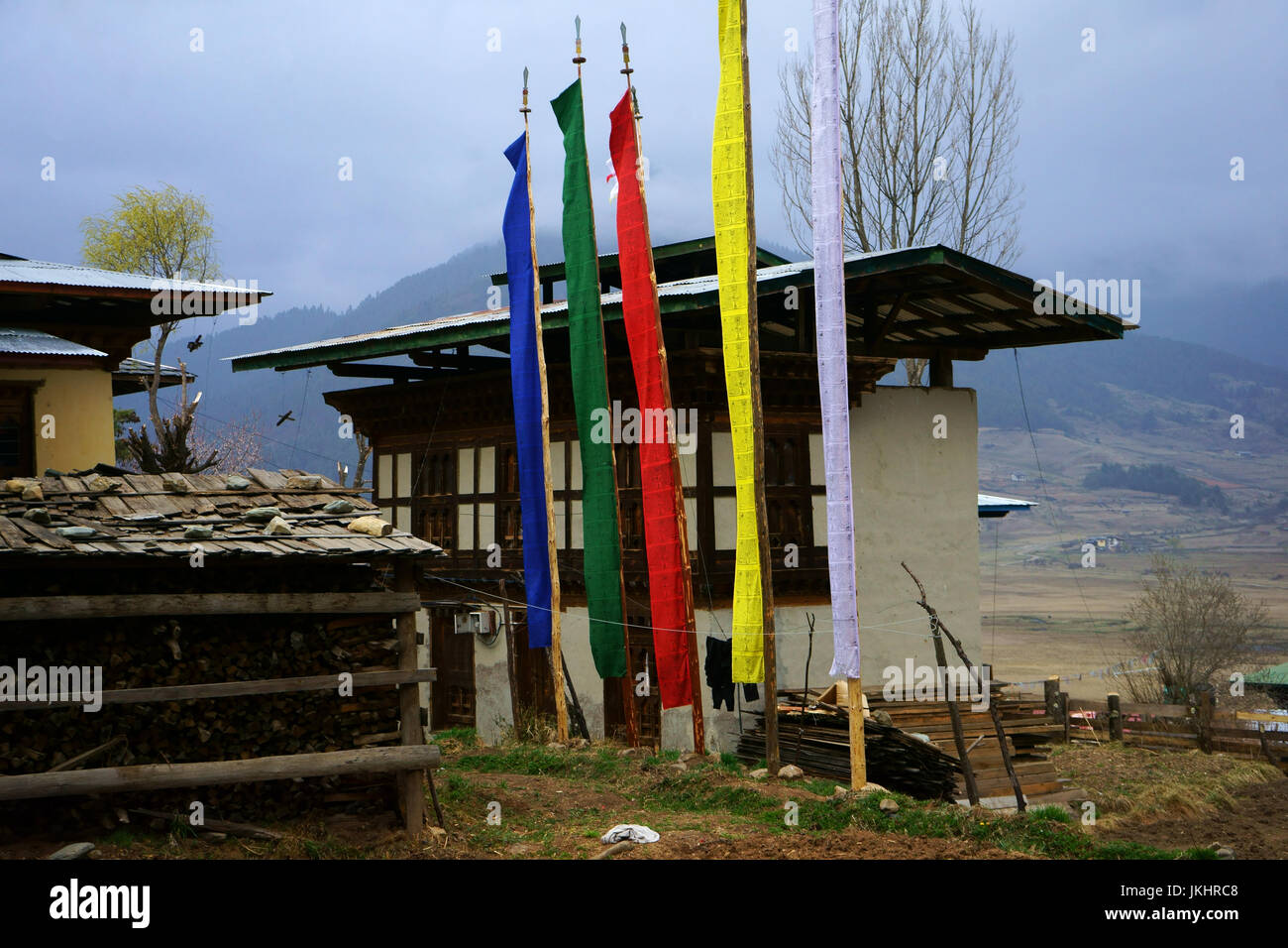 Farmbuildings with prayer flag, Phobjika Valley, Bhutan Stock Photo