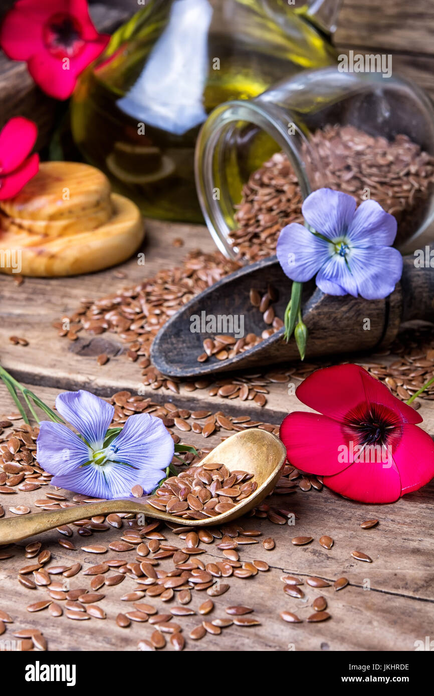 Flax seeds,flax flowers red and blue on a wooden retro background Stock