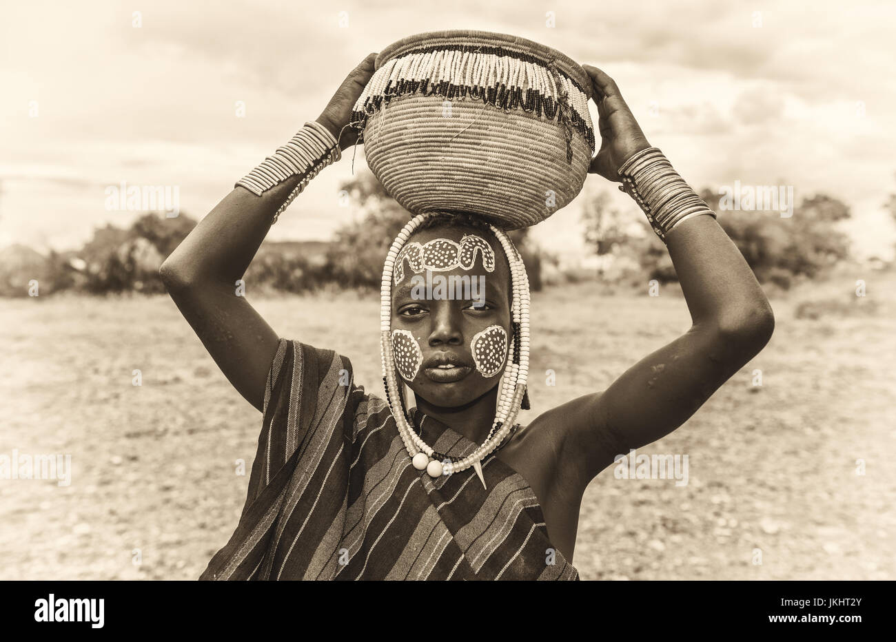 Young boy from the African tribe Mursi with traditional jewelry in Mago National Park, Ethiopia. Vintage black and white processed. Stock Photo