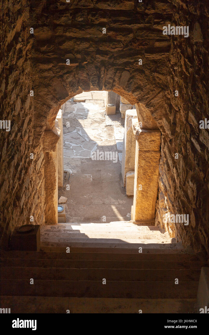 Dark entrance to house ruins with stone arc and columns in ephesus Archaeological site in turkey Stock Photo