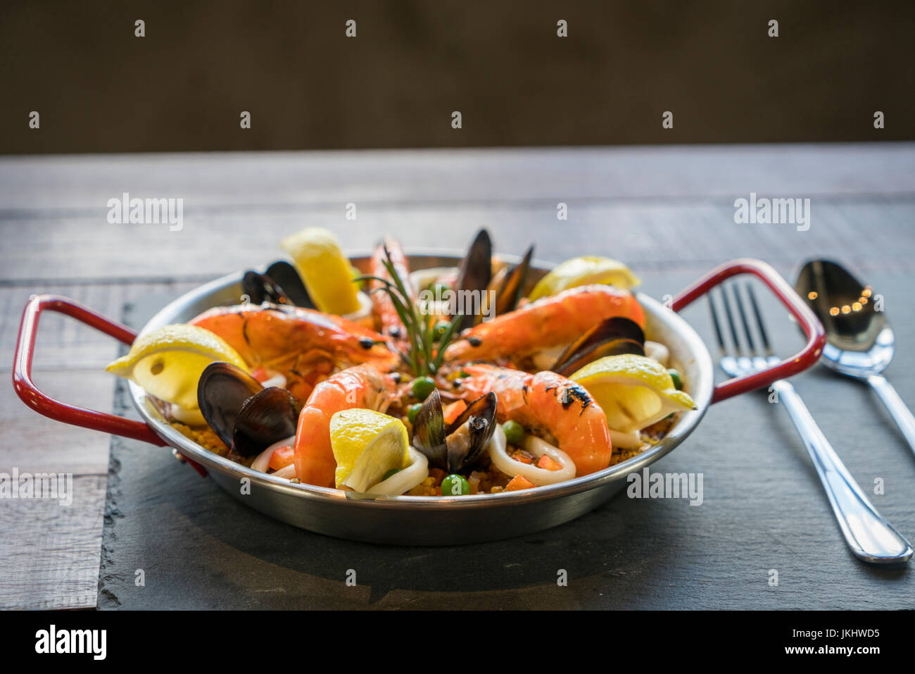Paella with seafood vegetables and saffron served in the traditional pan Stock Photo