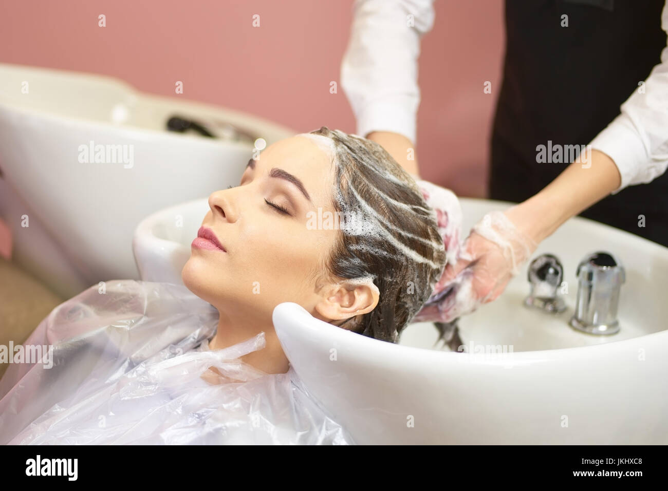 Woman getting her hair washed Stock Photo Alamy