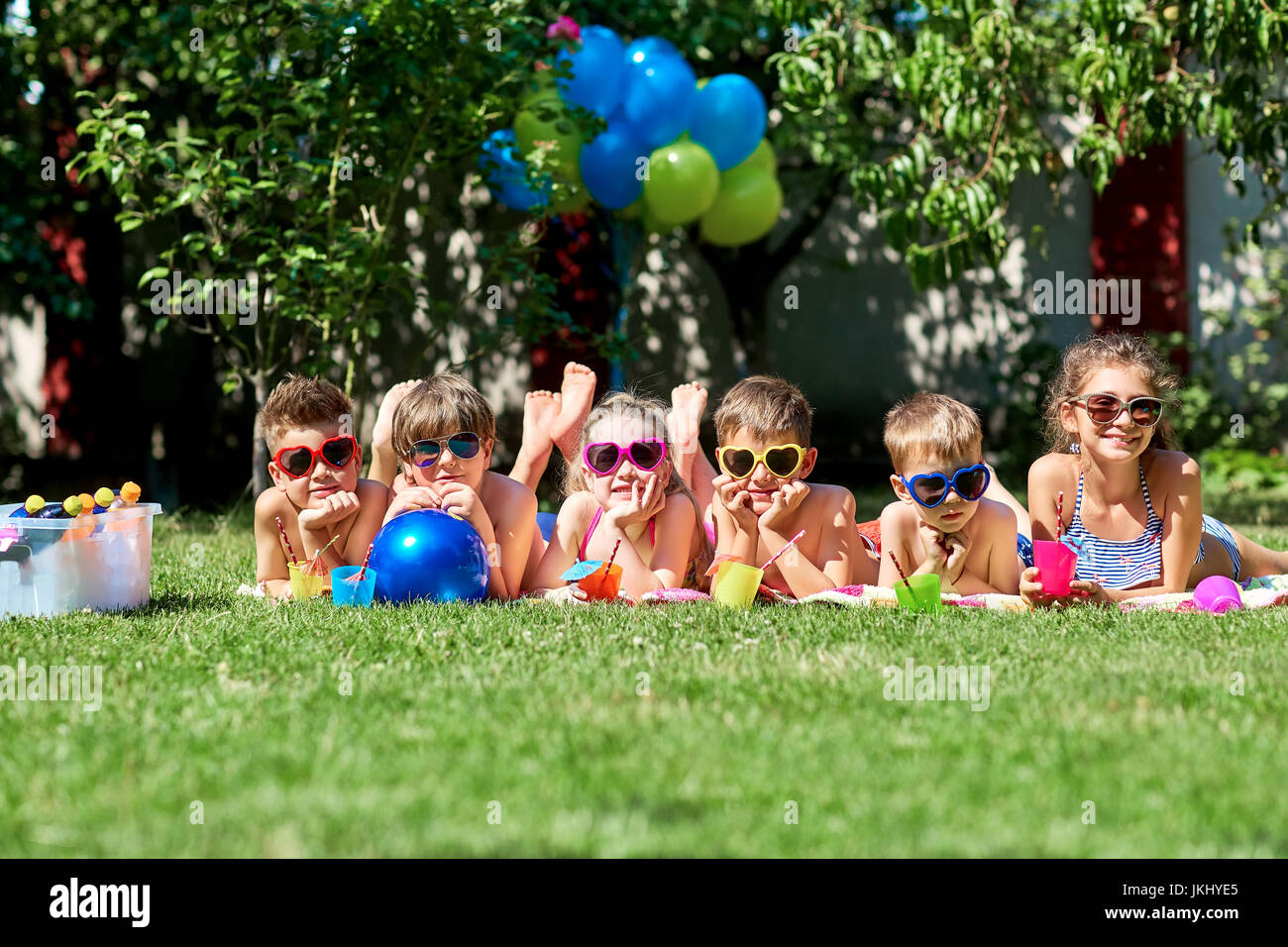 Group of children in sunglasses on grass in summer Stock Photo Alamy