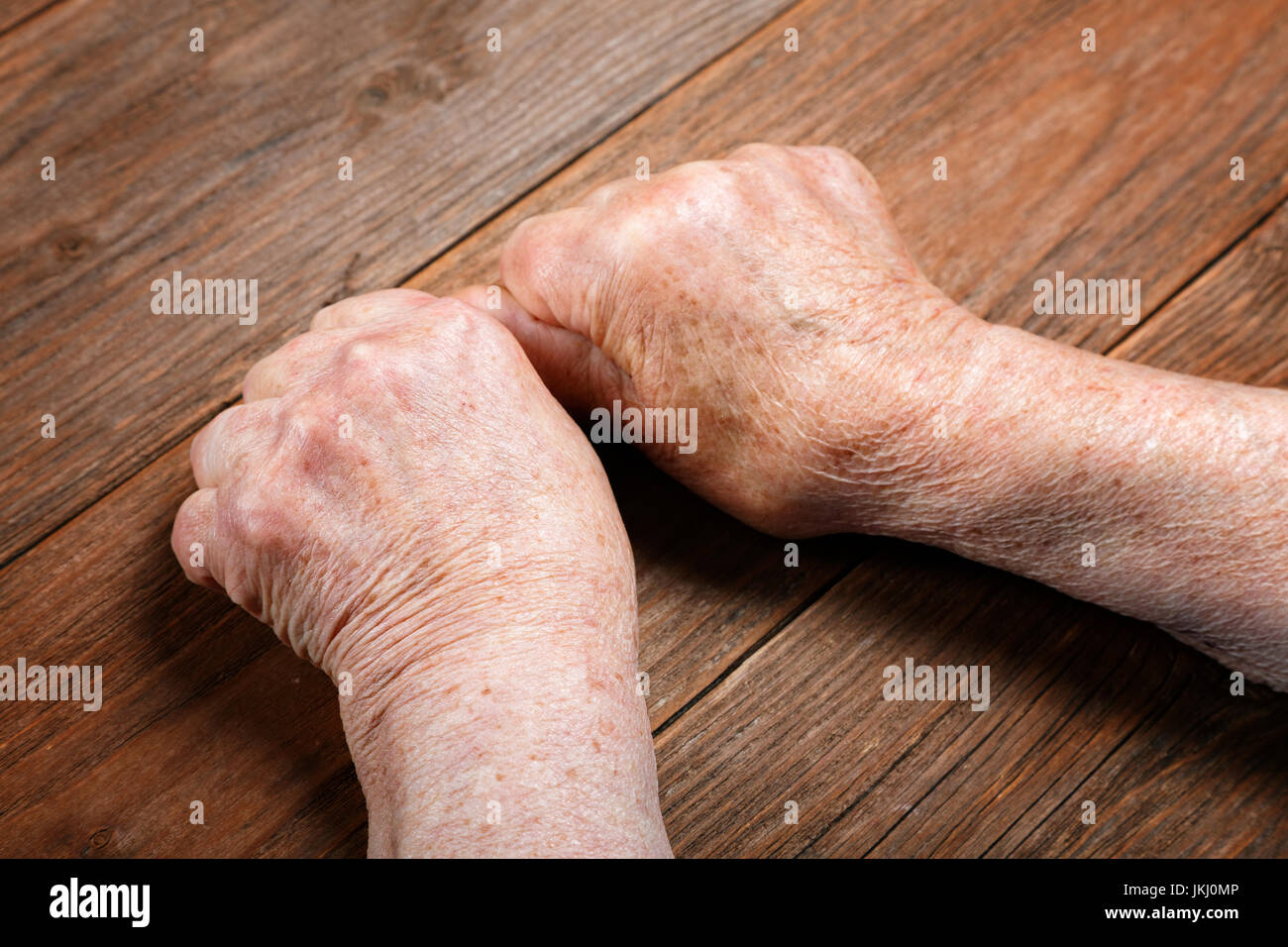 Hands of an old woman close-up on a table Stock Photo