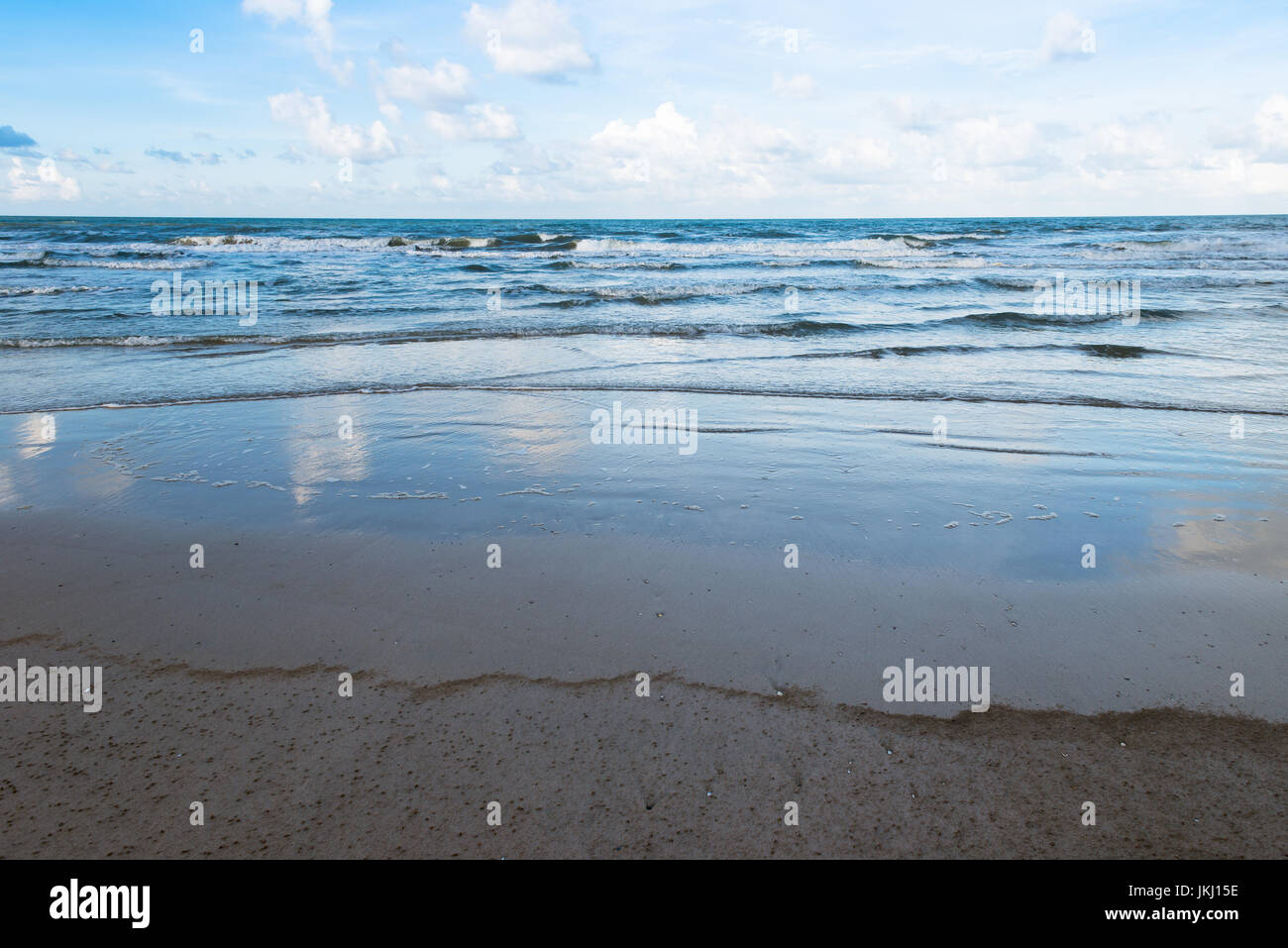 ocean wave and beach on blue sky and white cloudy Stock Photo - Alamy