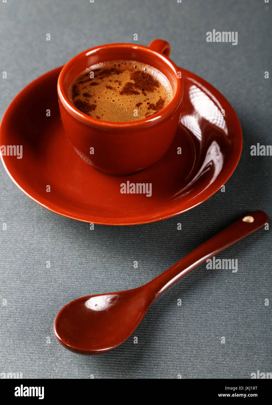Small cup of coffee with a spoon and saucer Stock Photo