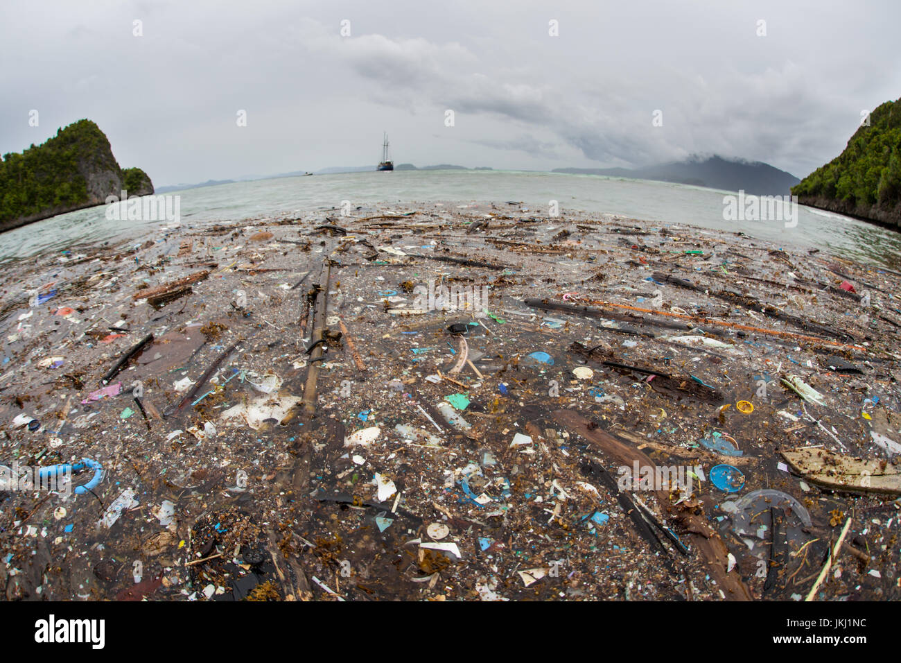 Discarded plastic washes up on a remote island in Raja Ampat, Indonesia. Plastic is an ever-growing environmental problem as it enters into food webs. Stock Photo
